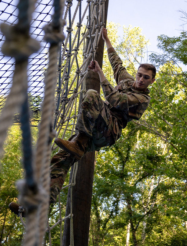 Cadet Luc Buth, from Niagara University with 5th Regiment, Advanced Camp, climbs down a rope net obstacle at The Confidence Course on Fort Knox, Ky., July 2, 2024. The Confidence Course pushes Cadets to their limits, with focus on their endurance, resilience, and solidarity. Throughout a series of exercises, Cadets test their physical capabilities, they receive either a "go" for completion or a "no-go" for failure. |Photo Credit: Ayiana Andrella, Ohio University, CST Public Affairs Office