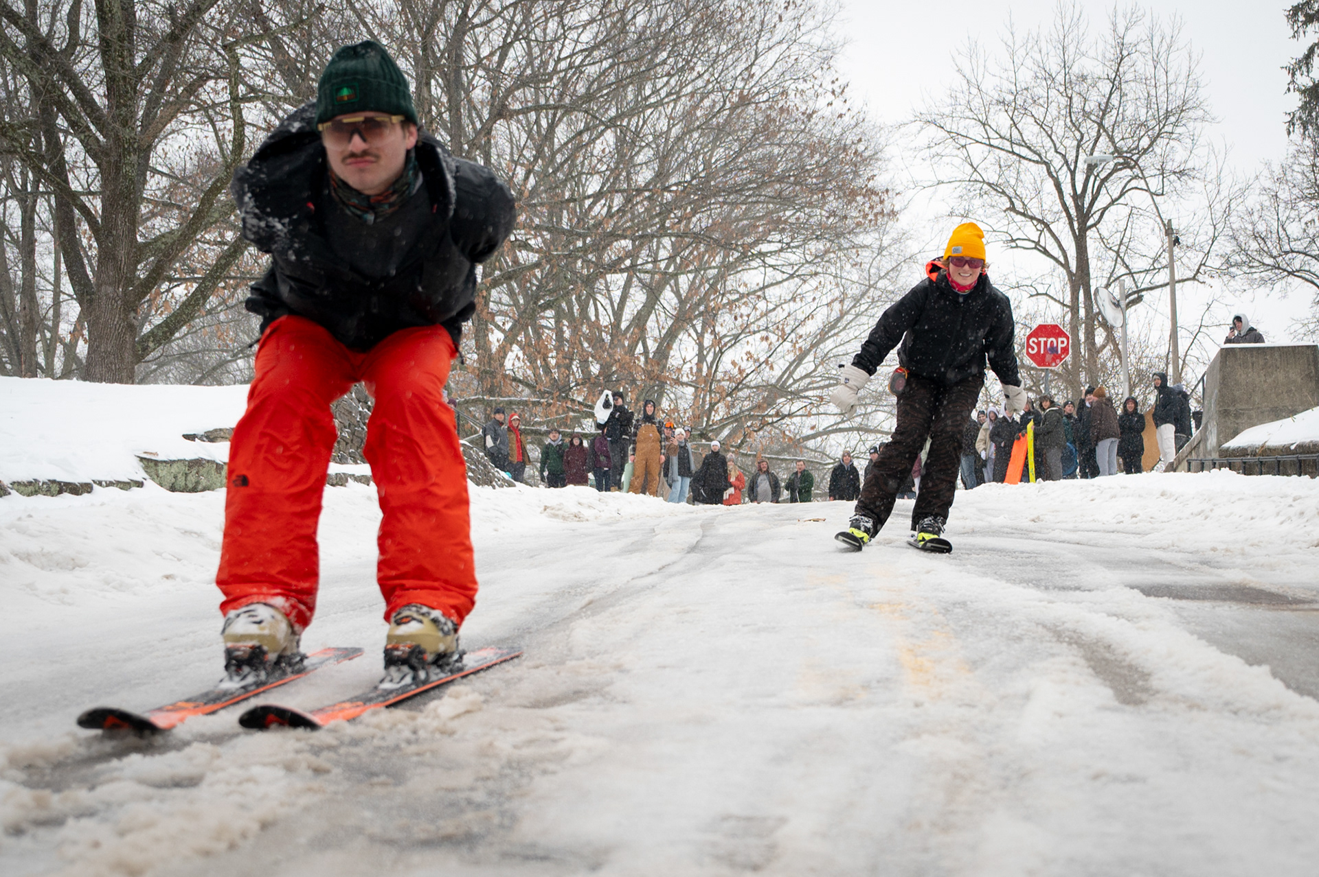 Ben Pirain (left), a senior and Lyla Williams (right), a freshmen, skis down Jeff Hill during the club’s “Snow Day” event in Athens County on Sunday, Jan. 25, 2026. Snowcats promoted the event through social media, inviting students to sled, ski, and snowboard despite hazardous conditions. Students arrived with traditional sleds and skis as well as improvised options like trash can lids and IKEA bags, until police shut down the gathering around 1 p.m. due to safety concerns.