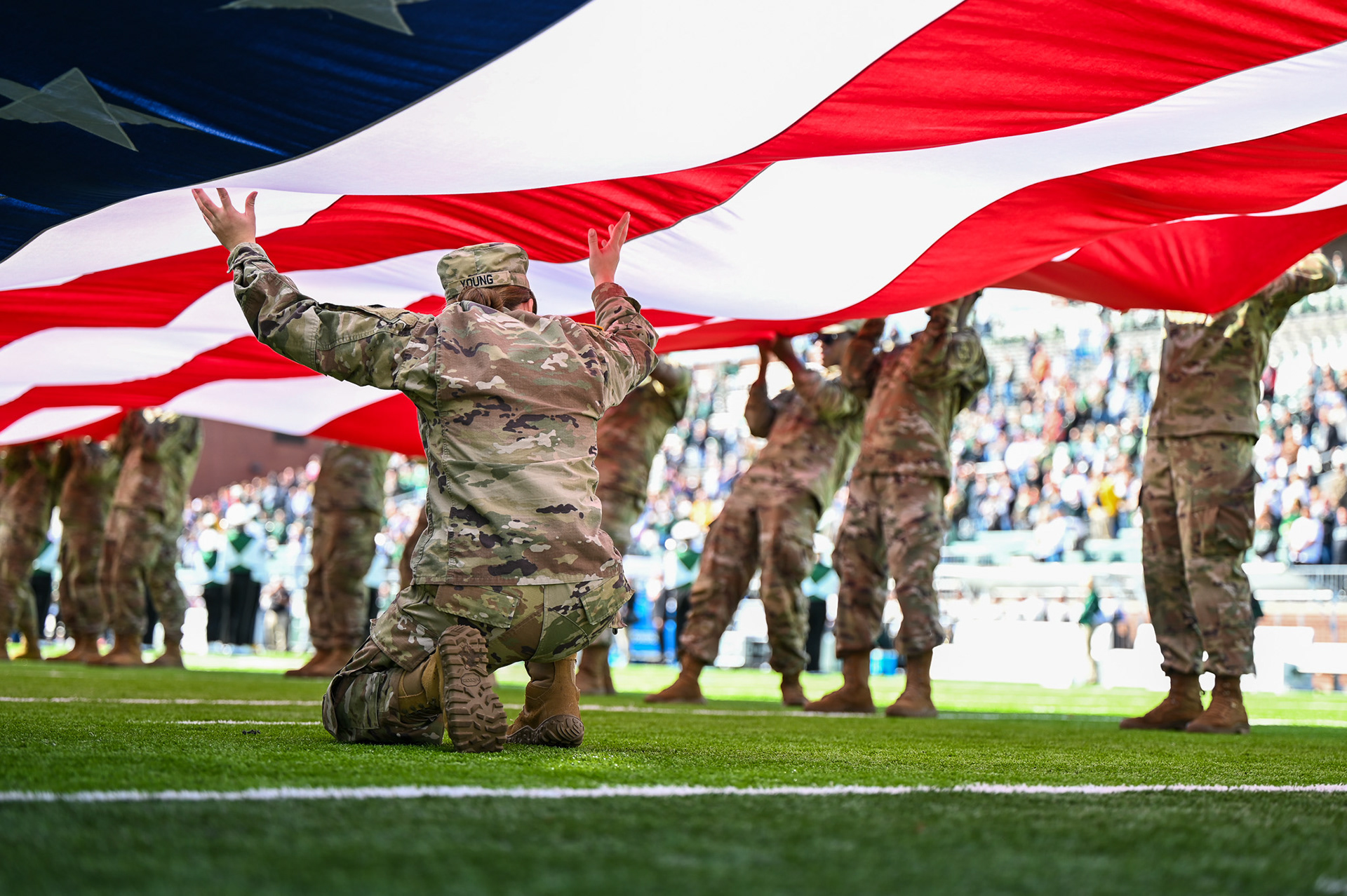 Cadet Madeline Young, alongside her comrades, hold the American flag during the national anthem at Ohio University’s Military Appreciation Game at Peden Stadium in Athens, Ohio, on Saturday, October 26, 2024. The Ohio Battalion performs the flag presentation each football season, honoring contracted ROTC Cadets with a swearing-in ceremony. This tradition celebrates the strong relationship and mutual support between Ohio ROTC and the university.