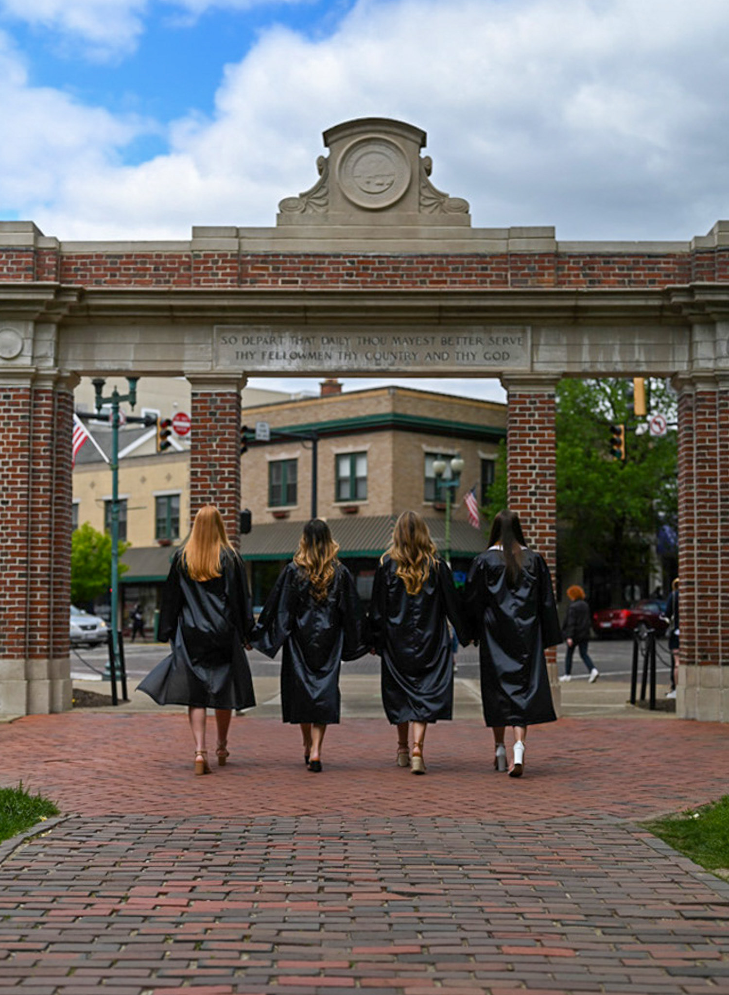 College graduates pose for senior photos on the College Green at Ohio University in Athens, Ohio, on Sunday, April 21, 2024.