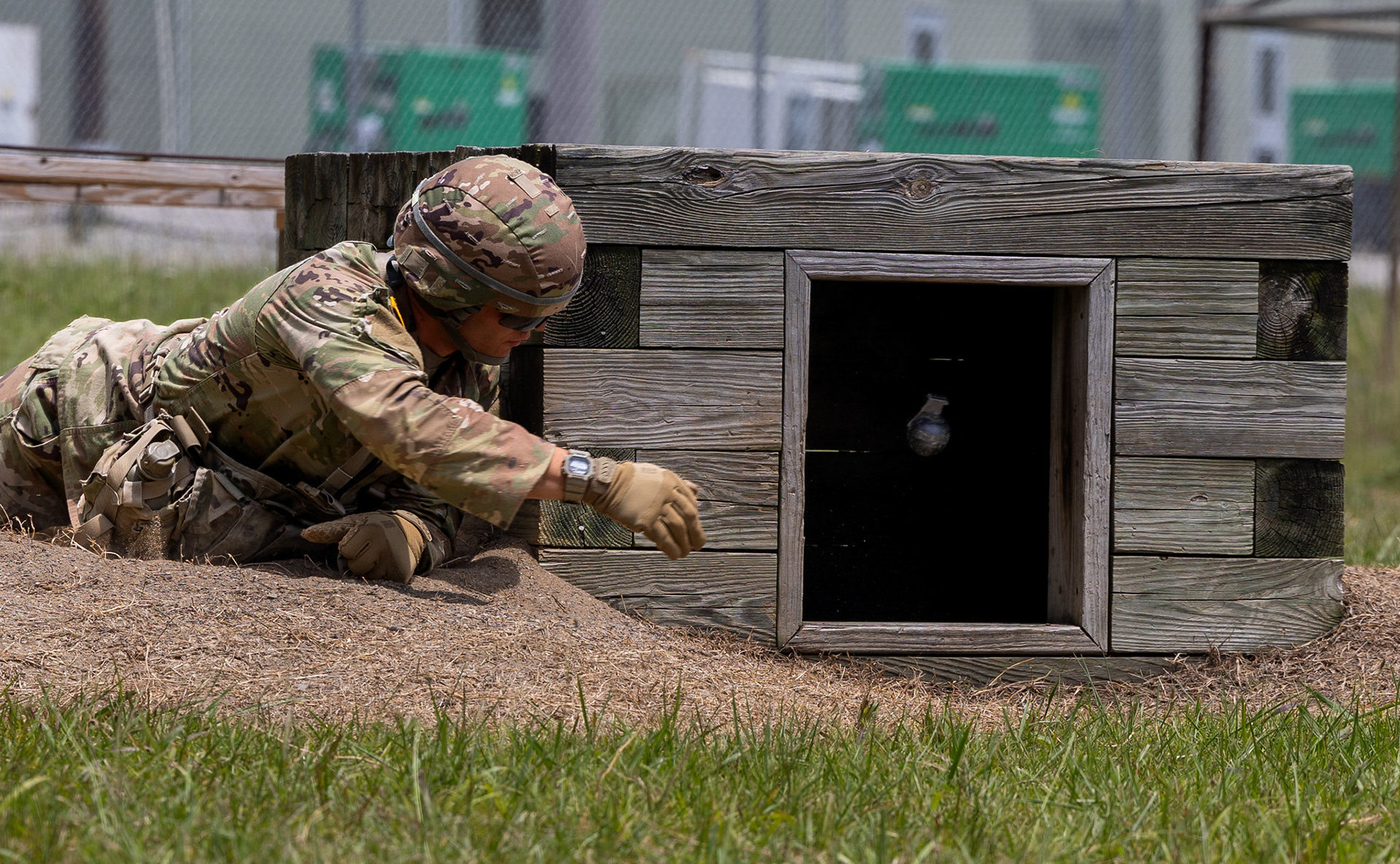 Cadet Sean Sasso from Georgia Military College, with 2nd Regiment, Advanced Camp throws a practice grenade into the bunker at the Hand Grenade Assault Course on Fort Knox, Ky., June 14, 2024. The Hand Grenade Assault Course requires Cadets to go through a lane that consists of 7 tasks, each lane has Cadets to navigate various obstacles while engaging targets by throwing practice grenades from 5 different positions. | Photo Credit: Ayiana Andrella, Ohio University, CST Public Affairs Office