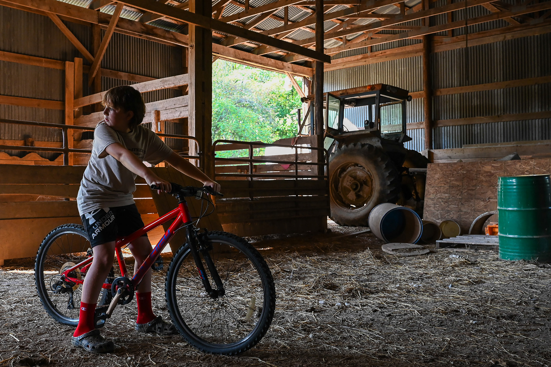Jared Rayner, grandson of Tom Rayner, gazes outside the cow barn on Rayner's Range, Saturday, September 14, 2024. This land, passed down from Tom's parents to him, represents a legacy of hard work and dedication to family values. Tom hopes to pass it on to his sons, ensuring that the range and farm continue to thrive for future generations. “I’ll retire when they put me in the dirt." said Rayner. "My sons have said they’d like to keep the range going after we’re gone.” Inspired by his family's history, Jared shares his own dreams of farming, expressing a deep desire to one day call this land his own and continue the legacy of Rayner's Range.