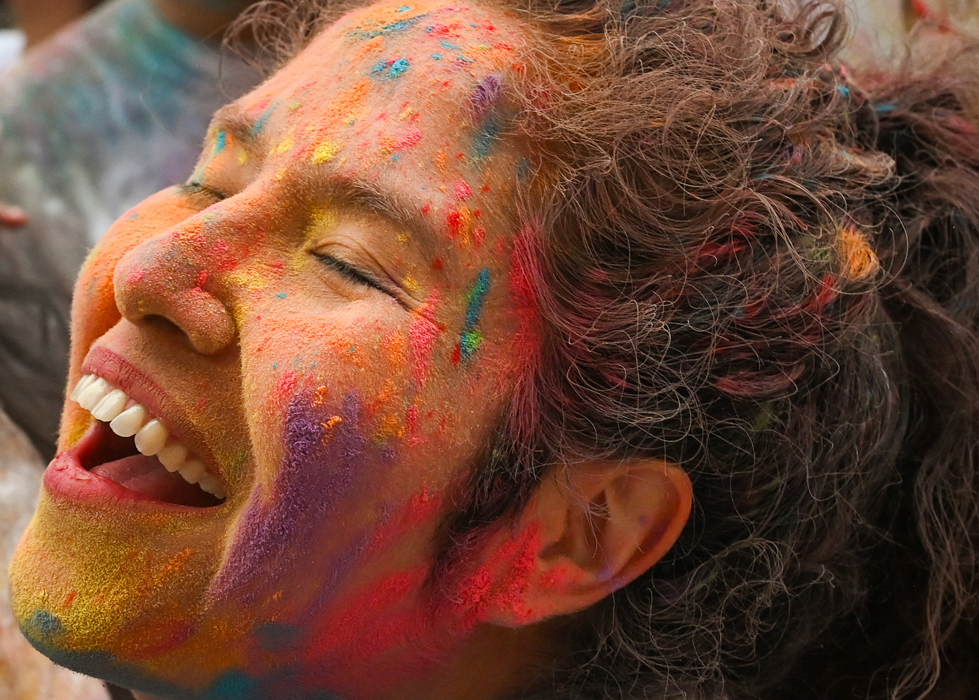 A woman smiles and celebrates the vibrant colors of Holi during the “Holi in the District” event at Union Market in Washington, D.C., on Friday, March 14, 2025. Holi, a vibrant Hindu festival, marks the arrival of spring, celebrates the victory of good over evil, and honors the spirit of love and togetherness. The event allowed guests to enjoy authentic Indian flavors, dancing, music, and the tradition of color throwing.