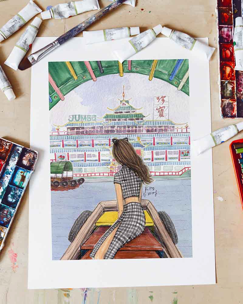 Flatlay of fashion illustration of girl and Aberdeen Jumbo Boat painting, surrounding by paint tubes and paintbrushes