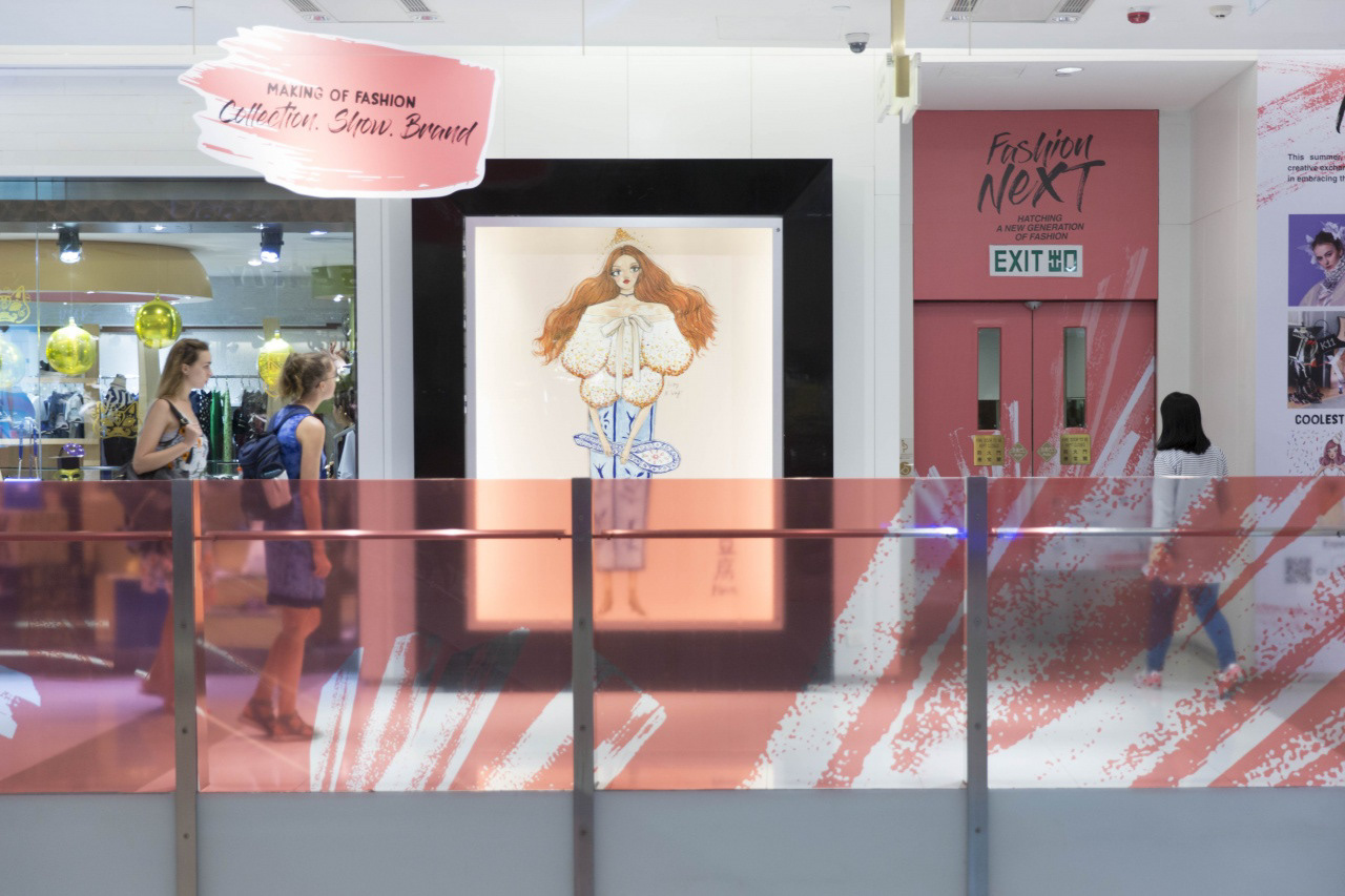 Two blonde shoppers looking at artwork display inside K11 mall