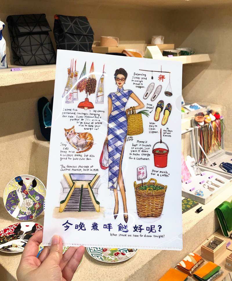 White plastic stationery file folder with Miss Central Market artwork inside store in Central Market