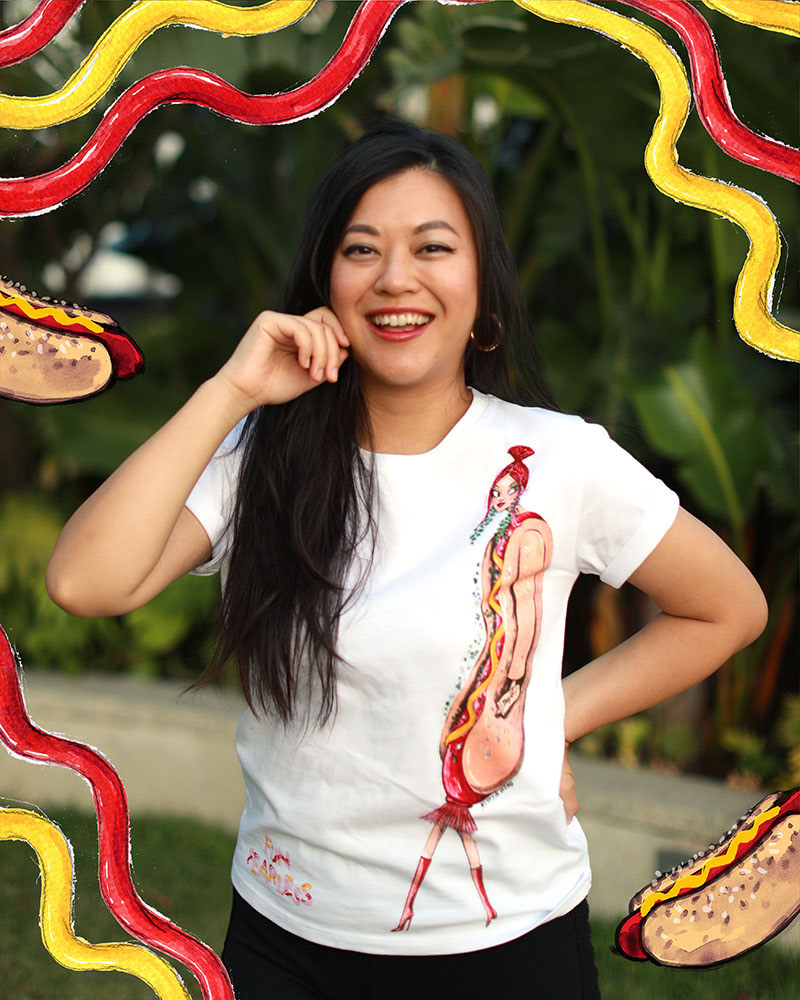 Woman artist Kitty Wong wearing a white tshirt with a hot dog illustration on it