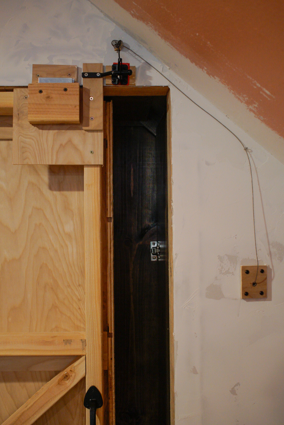 Latch mechanism: a gate latch is opened via the cable attached to a book