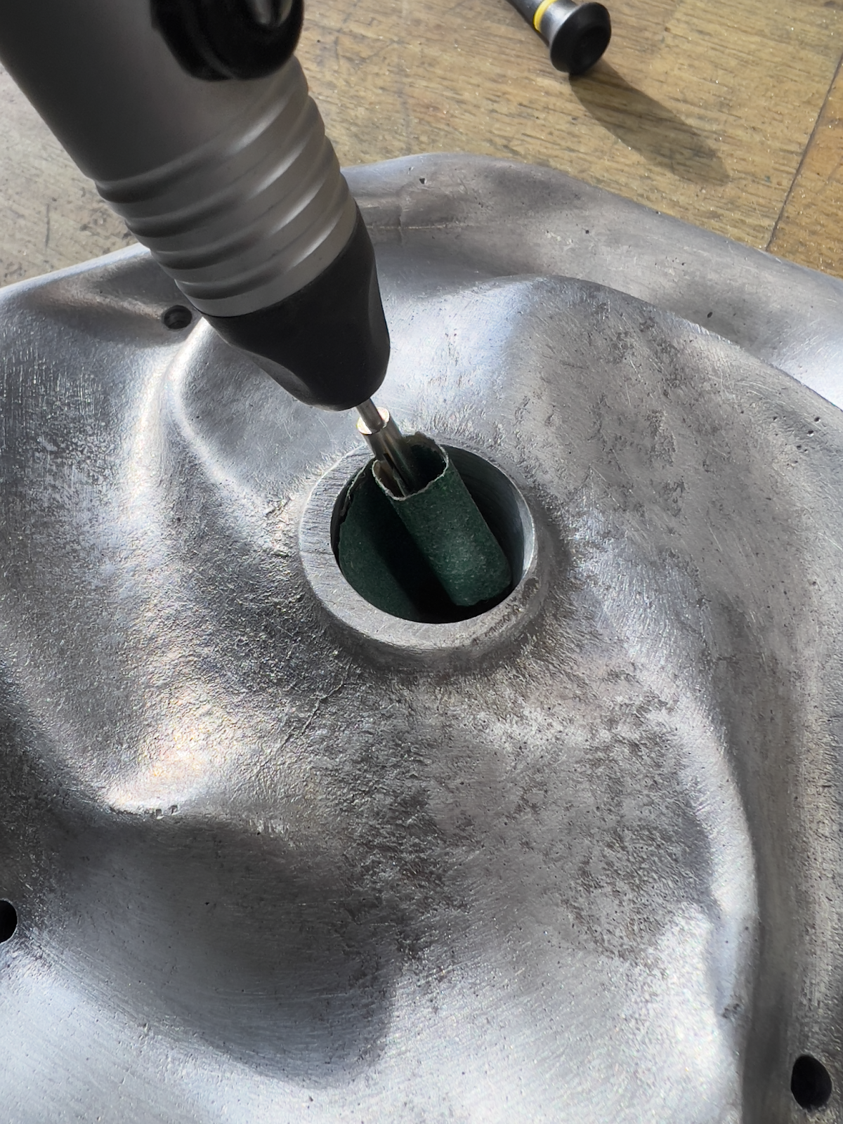 Sanding out the center mounting hole.