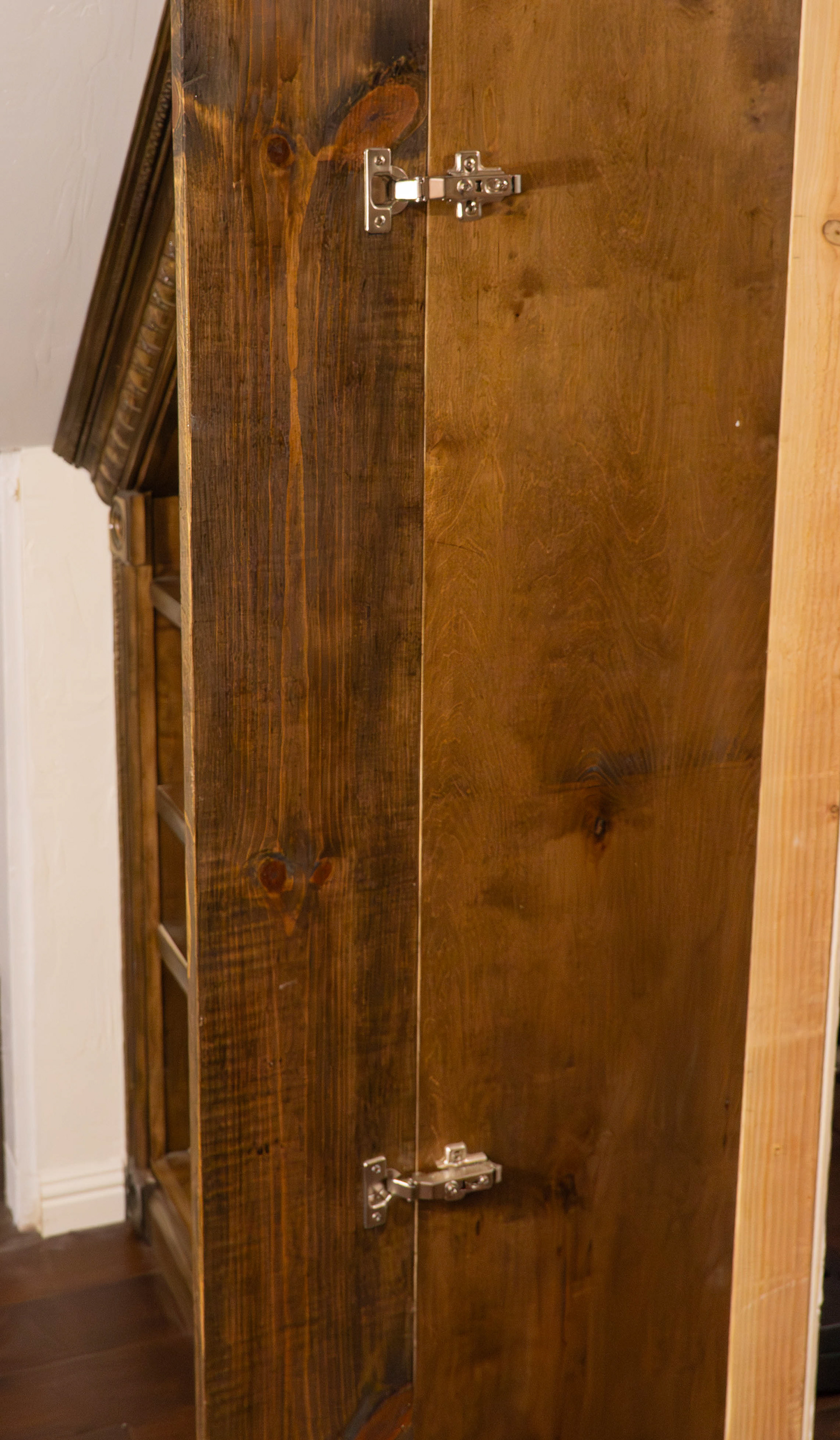 Trim surrounding the door opens via cabinet door hinges