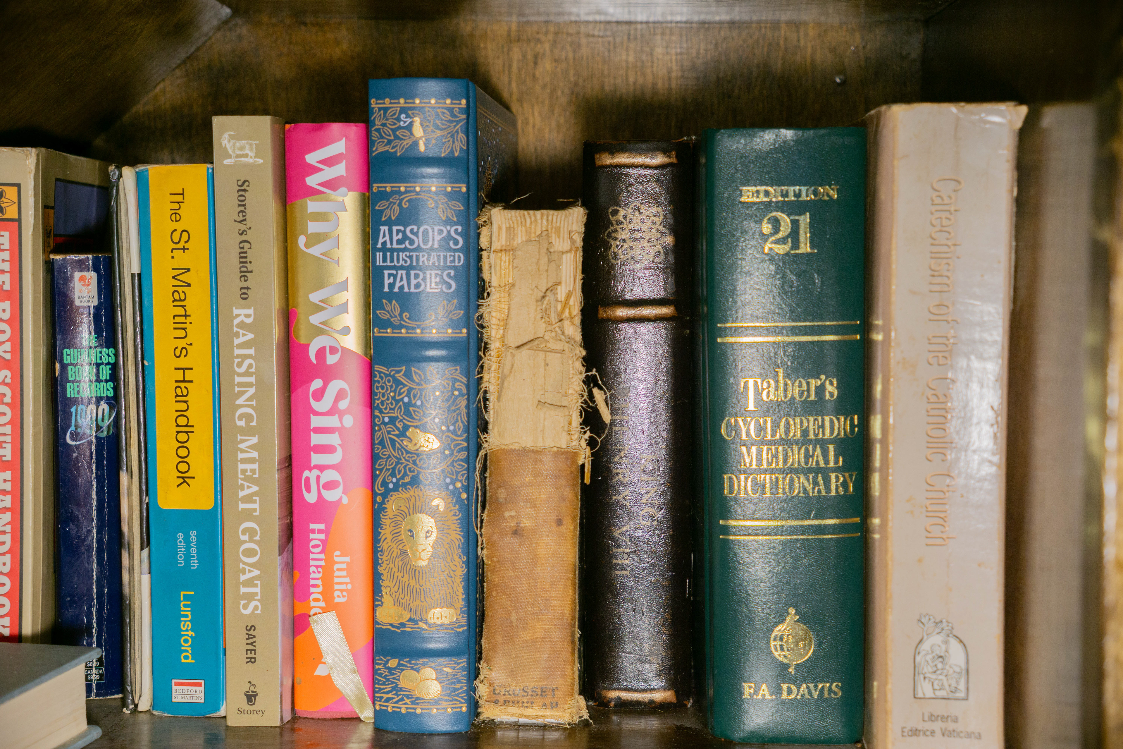 The tattered book in the center is the latch handle.