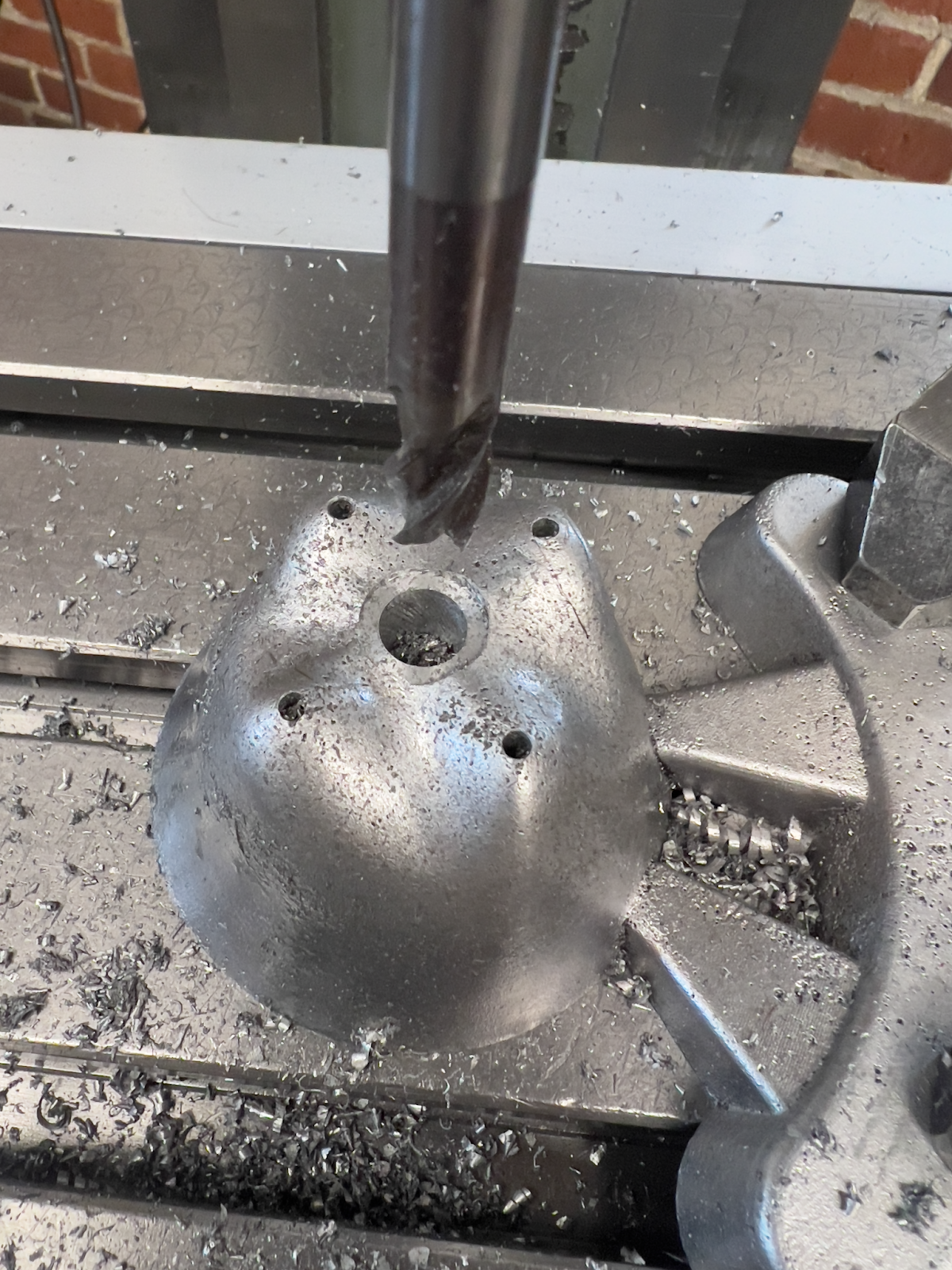 Boring the center of the top cup for mounting.