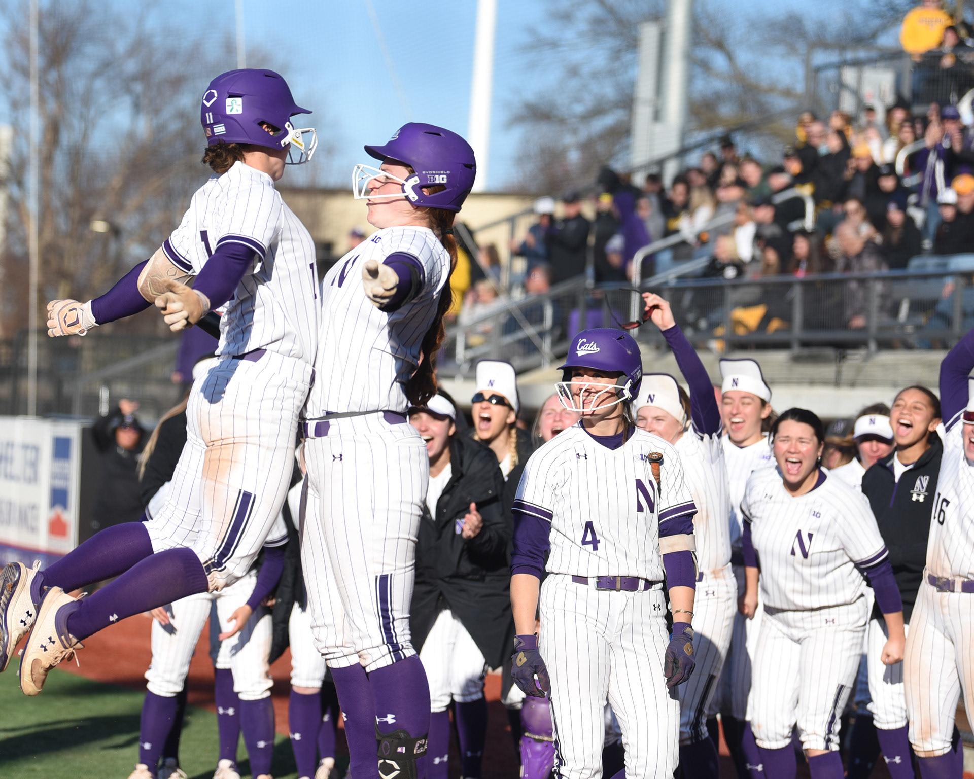 The Northwestern team celebrates a home run in the ninth inning.