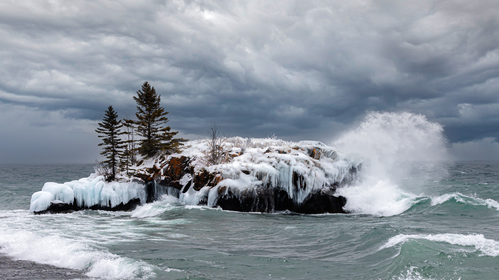 Hollow rock morning with wind, waves and ice