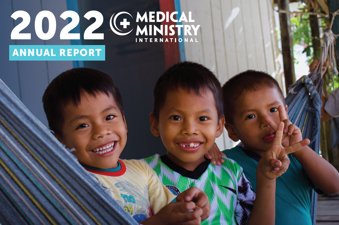 The cover of the 2022 Annual Report, three boys smiling in on a hammock