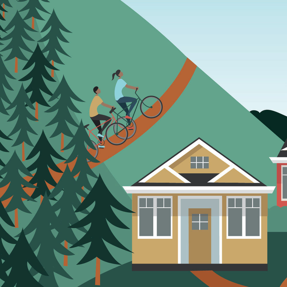 Detail of road sign. Two adults biking up a mountain with a home in the foreground.