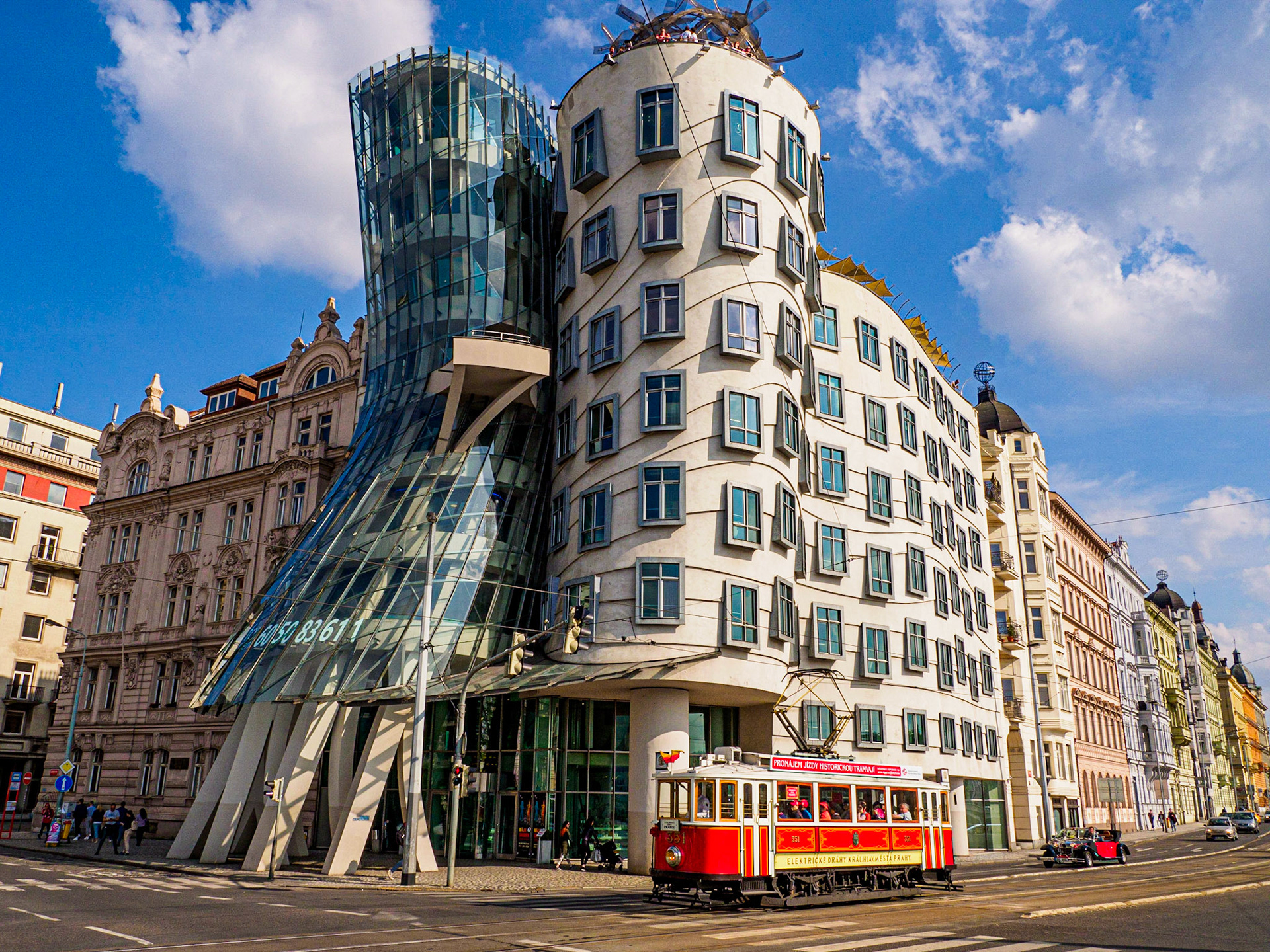 Dancing House, Prague, Czech Republic - On the bank of the Vltava River sits the Dancing House or Fred and Ginger Building. Built in the 90’s, it replaced a building destroyed by bombing in WWII. Deconstructivist architecture, the tower of stone represents the famous dancer Fred Astaire and the tower of glass represents Ginger Rogers.  It is remarkable when you come across it as It is such a stark contrast to the Baroque, Gothic and Art Nouveau architecture that surrounds it and what makes Prague to enchanting. • • • Olympus OM-D E-M1 MkII, M.Zuiko 12-100 f4.0 @ 26mm, 1/500, f11, ISO250 #olympusomd #olympusomdem1 #architecture #prague #praguearchitecture #getolympus