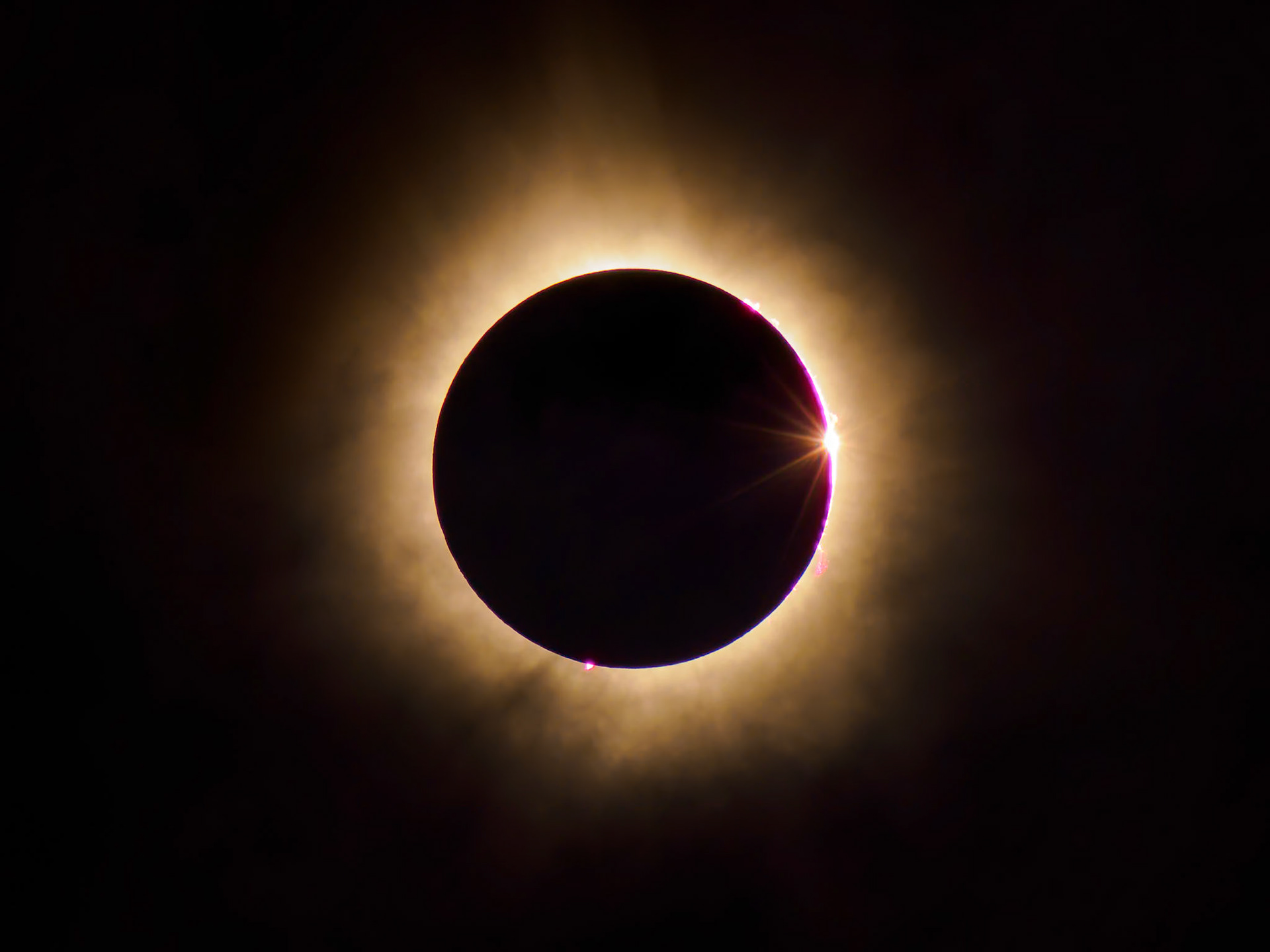 Totality finished, light peaking out again. Solar flares are clearly visible here as well.