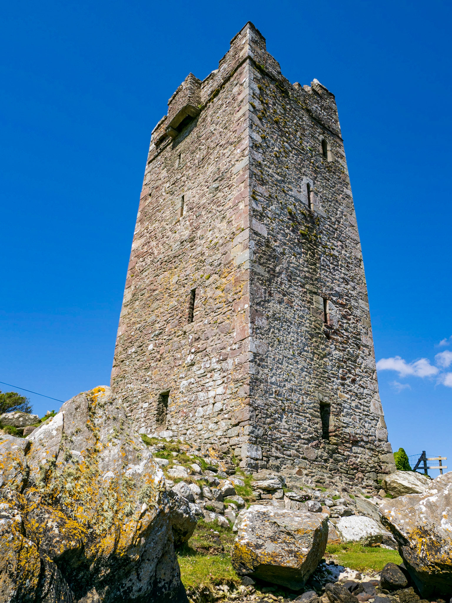The Tower at Kildavnet, in the south-east corner of Achill Island, is a perfect example of a 15th century Irish tower house. The Gaelic Chiefs of the time copied a Norman design and constructed many such tower houses. The tower at Kildavnet is thought to have been constructed by the Clan O’Malley in about 1429, but is associated locally with a descendant of the original builders, Grace O’Malley or Granuaile.