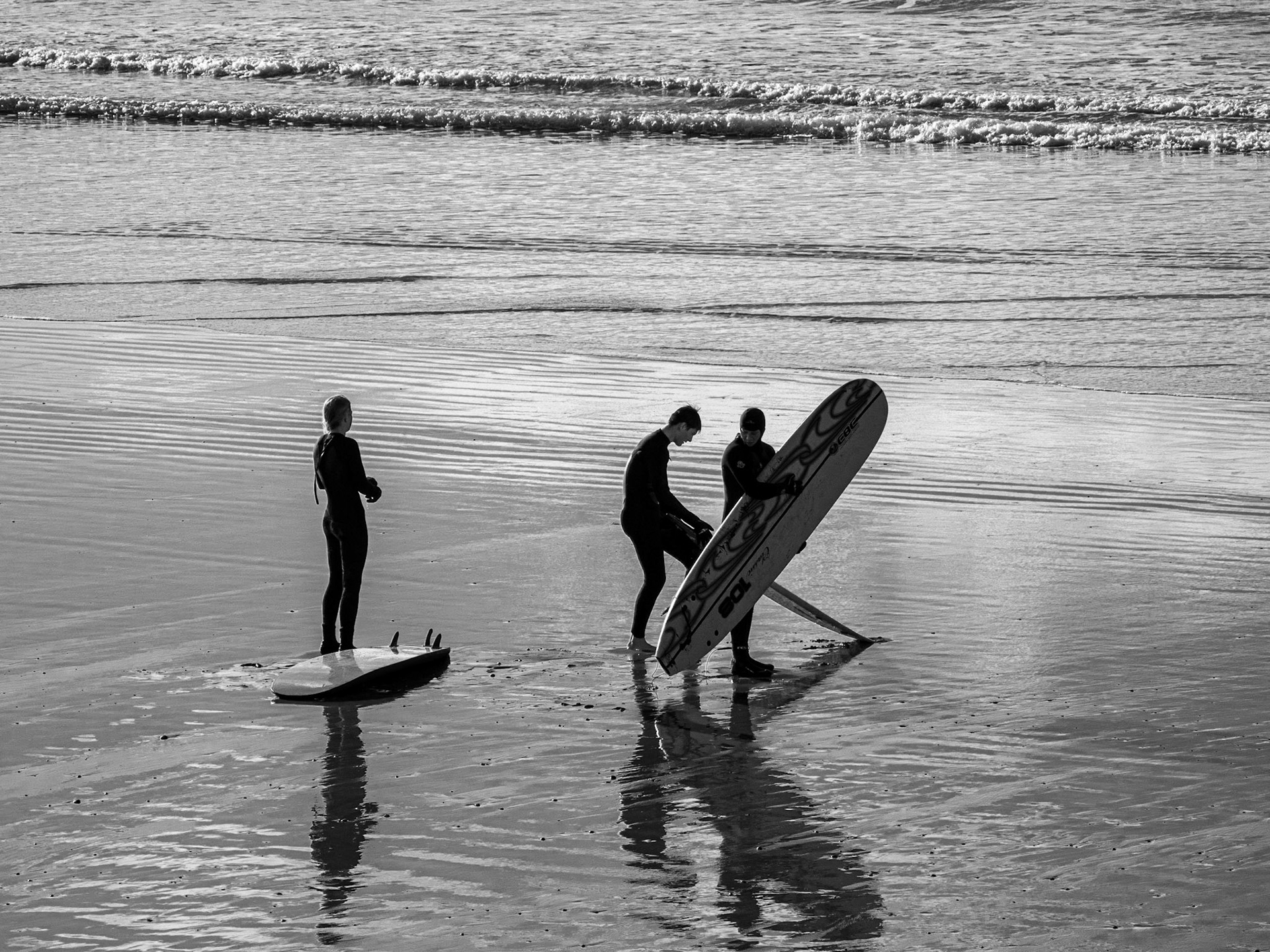 Surfers at Newgale Beach, Newgale, Wales, UK