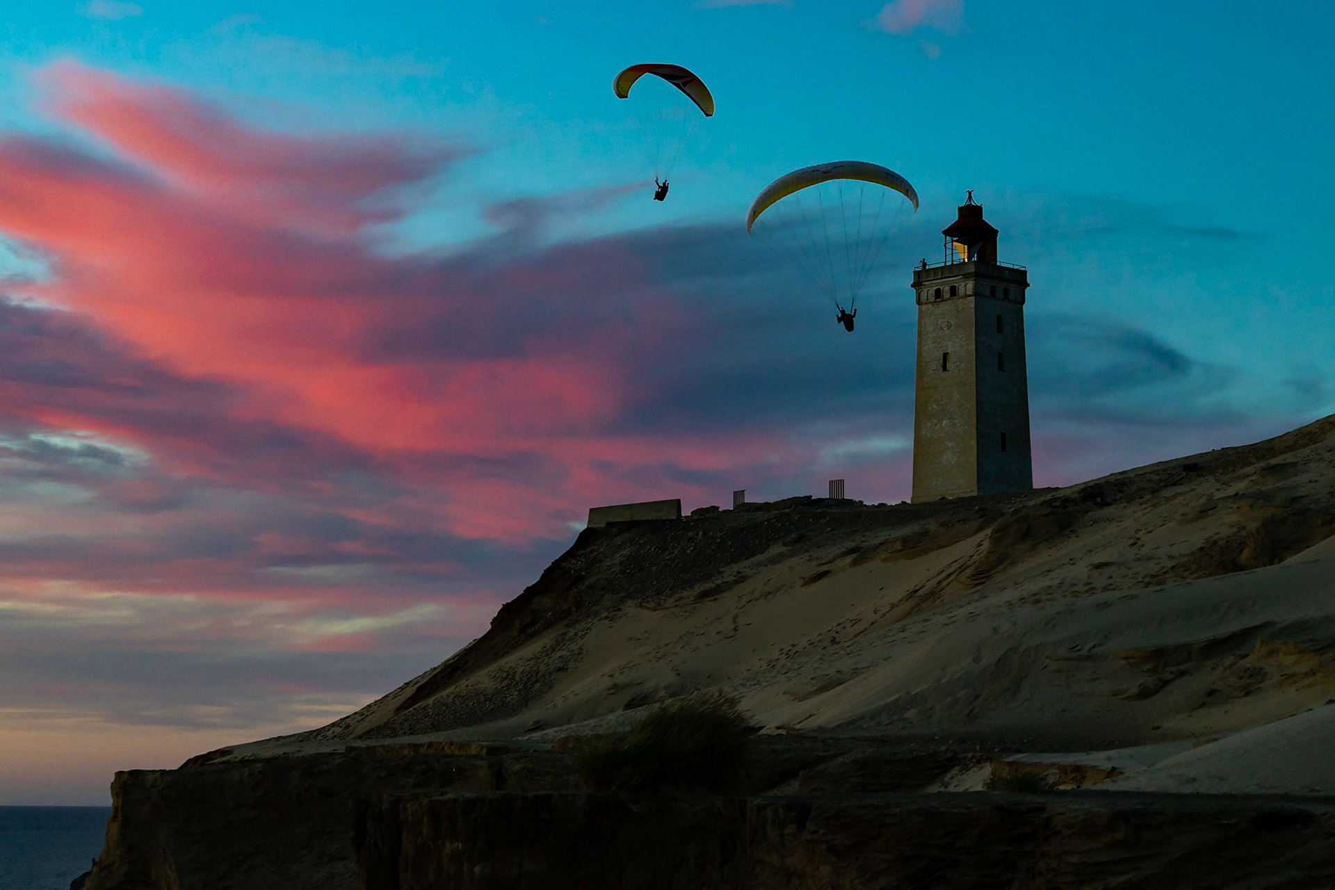Paragliders soaring near Rubjerg Knude Fyr in Denmark