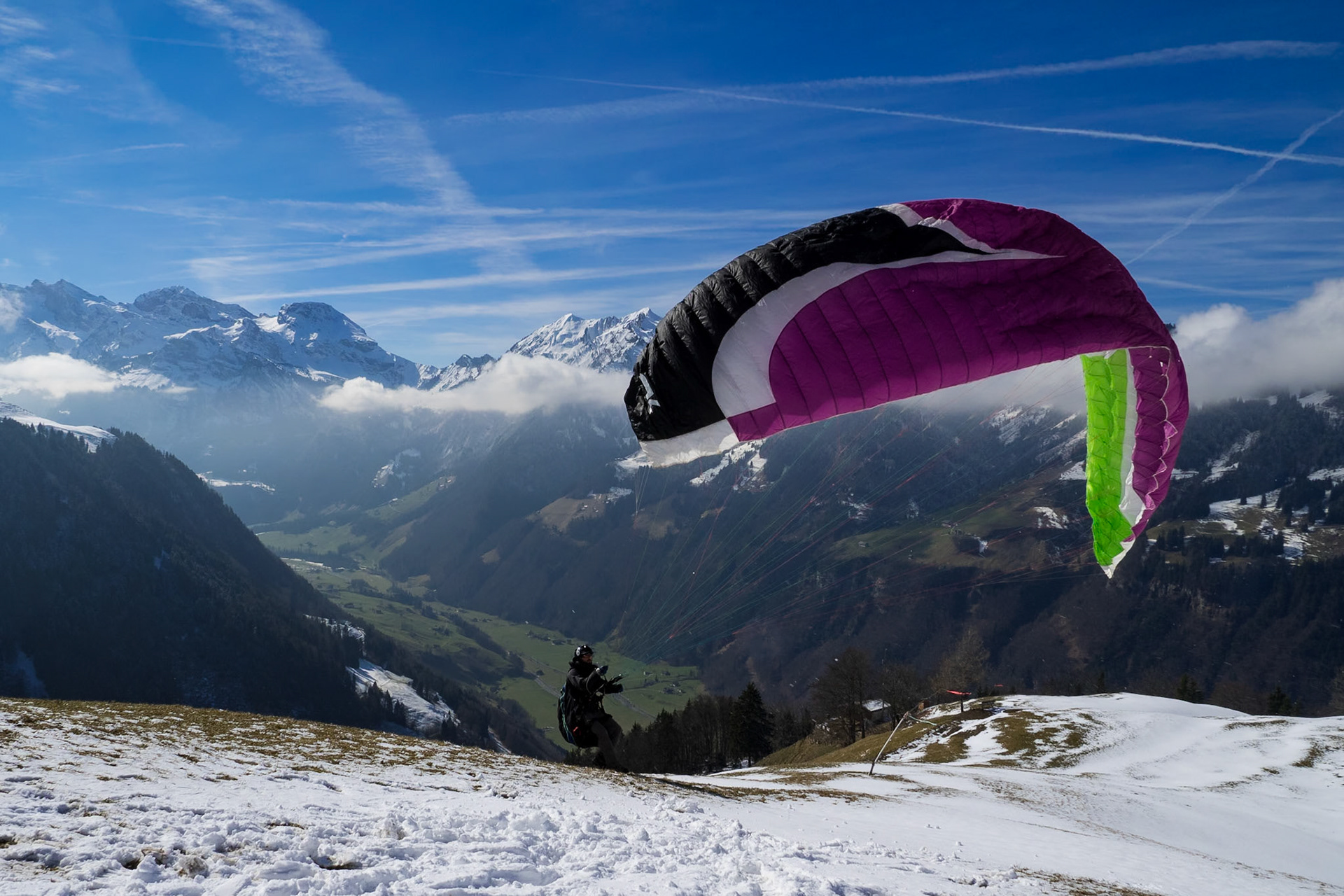 Paraglider starting in front of the Swiss mountain panorama