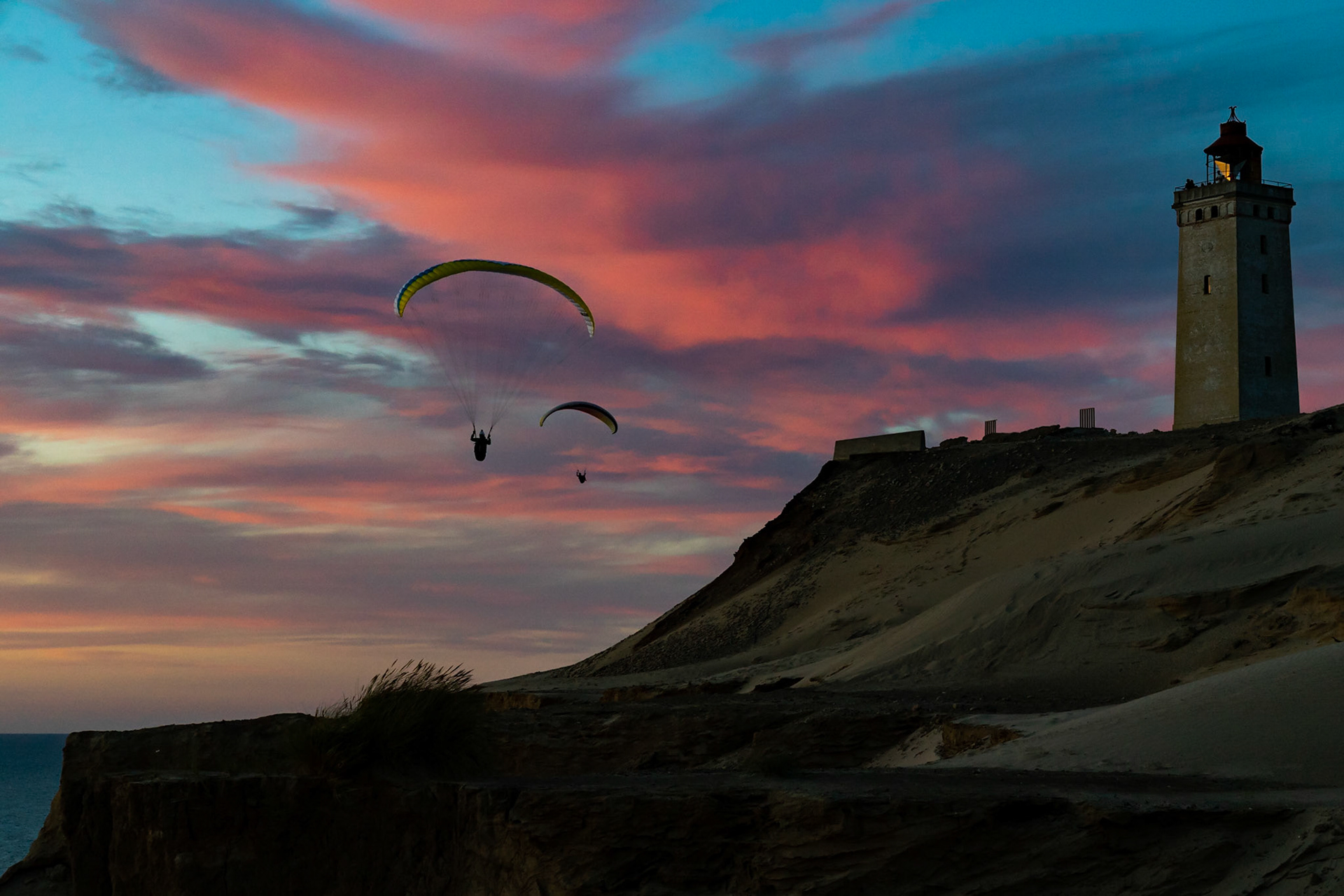 Paragliders soaring near Rubjerg Knude Fyr in Denmark