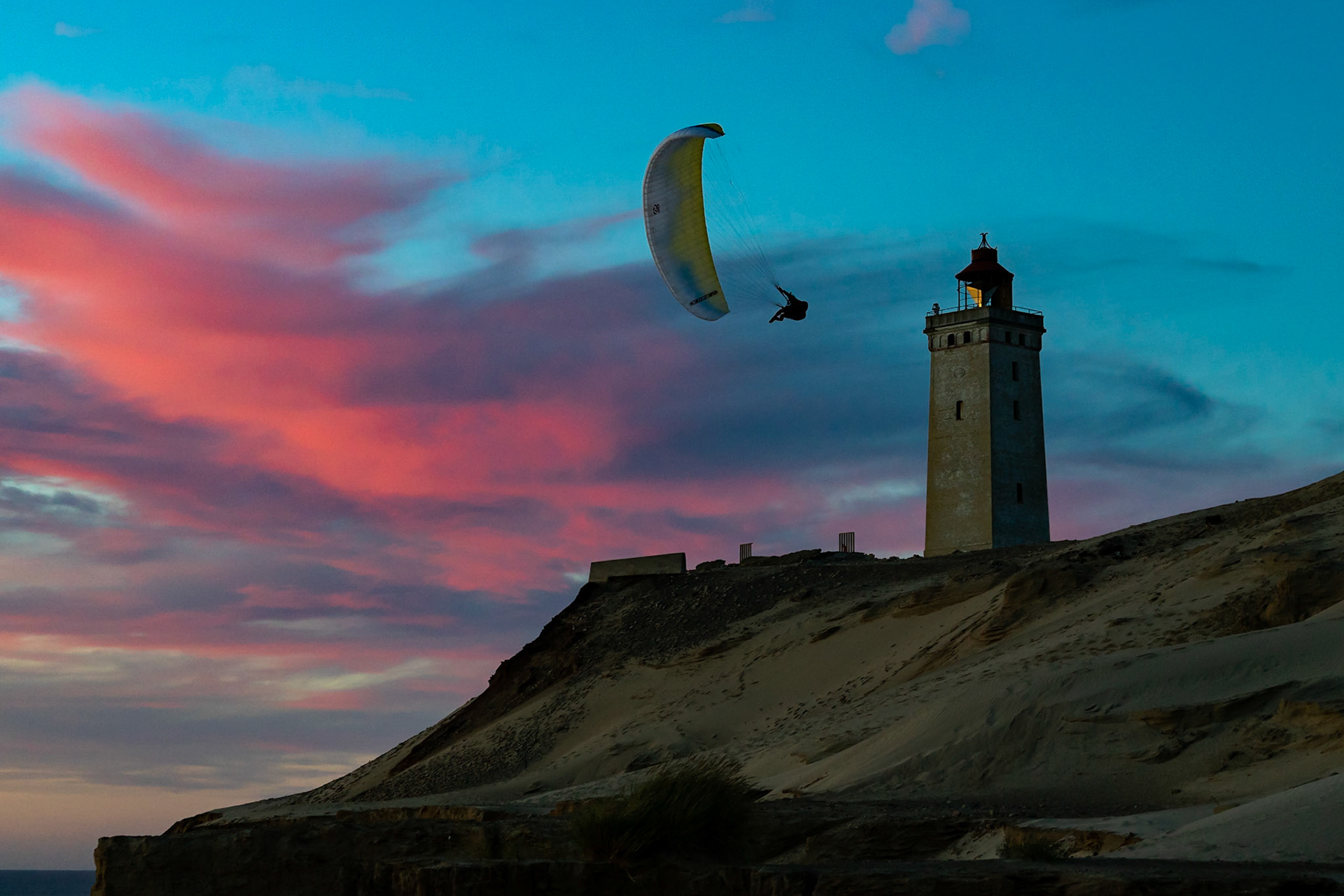 Paragliders soaring near Rubjerg Knude Fyr in Denmark