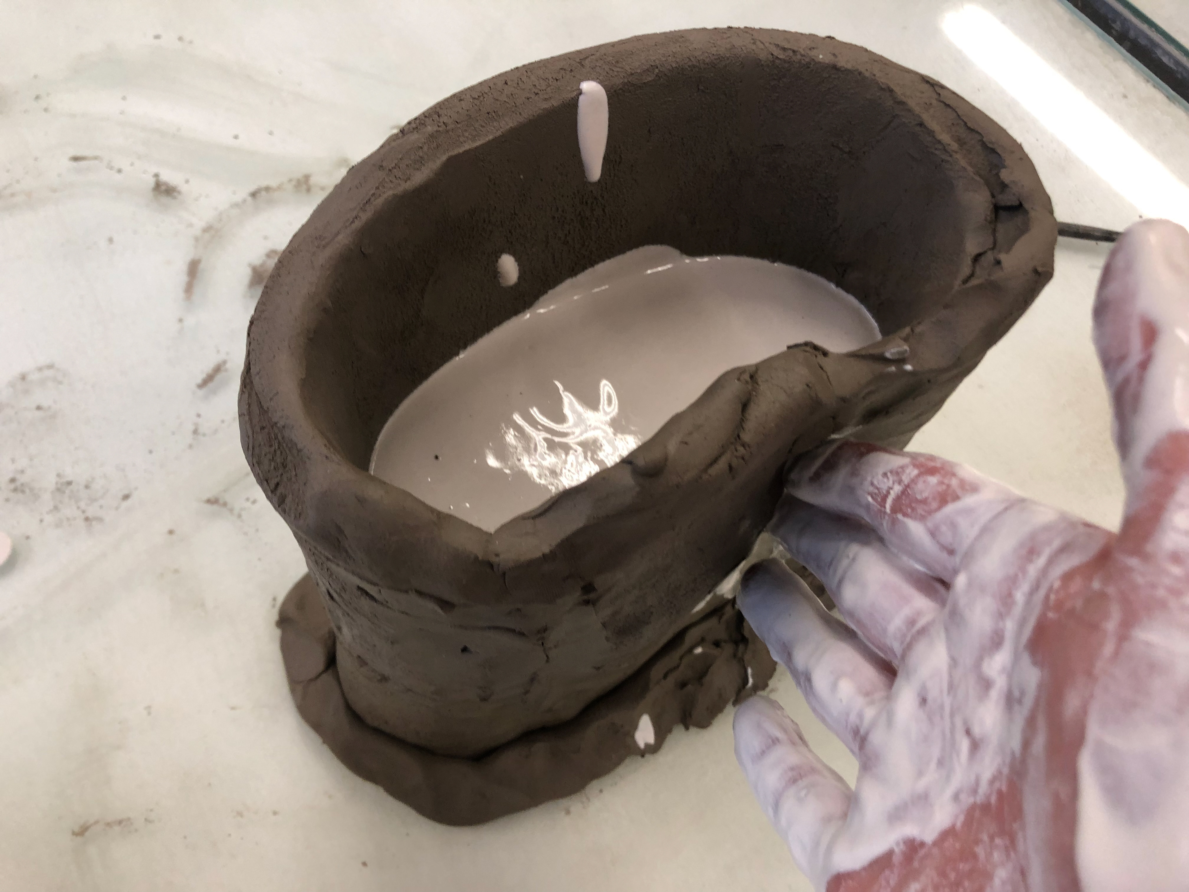Manipulation of the clay whilst the plaster sets.