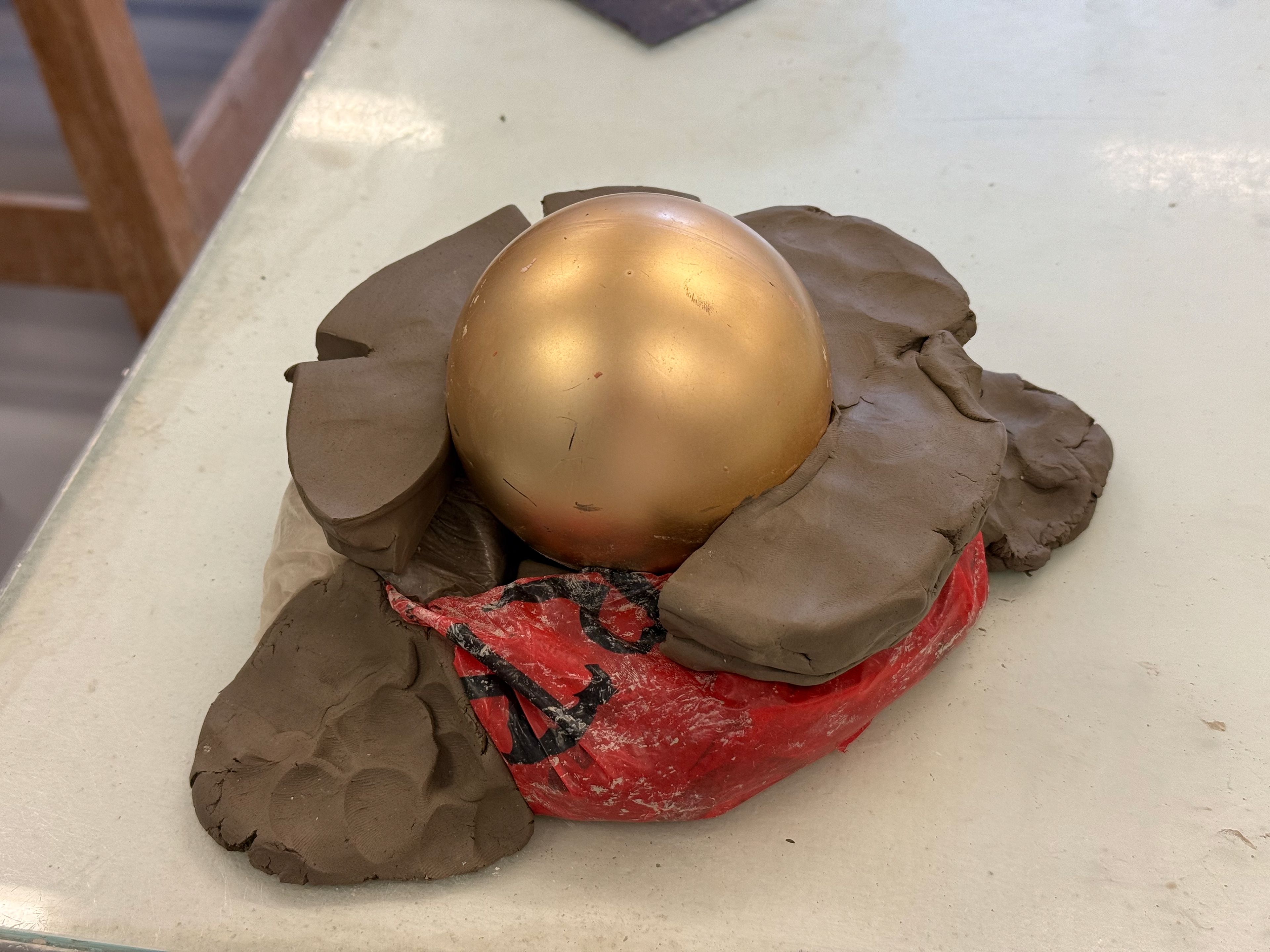 To ensure it was roughly even all the way around, I put thick blocks of clay around. Reaching just above the middle of the bauble.