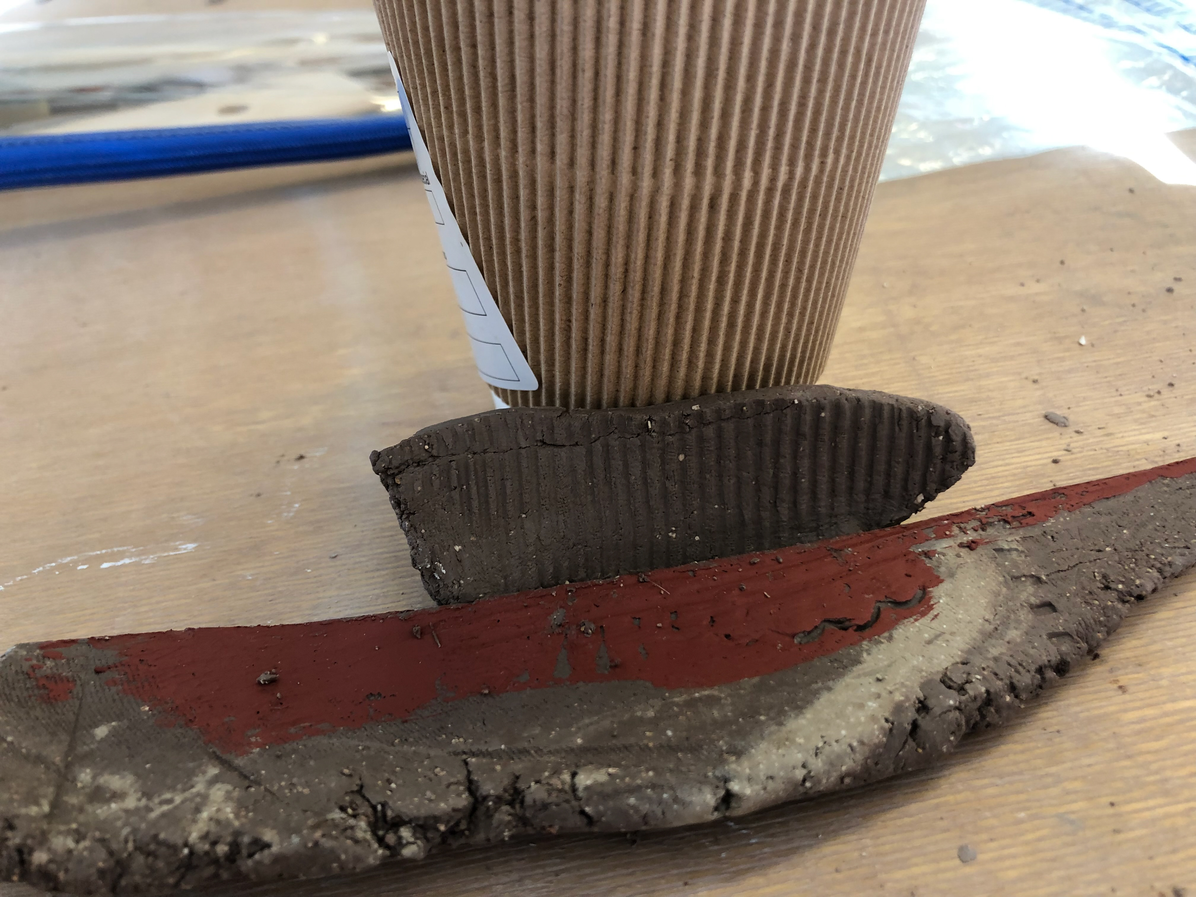 I wrapped clay around the side of a coffee cup to collect the pattern.