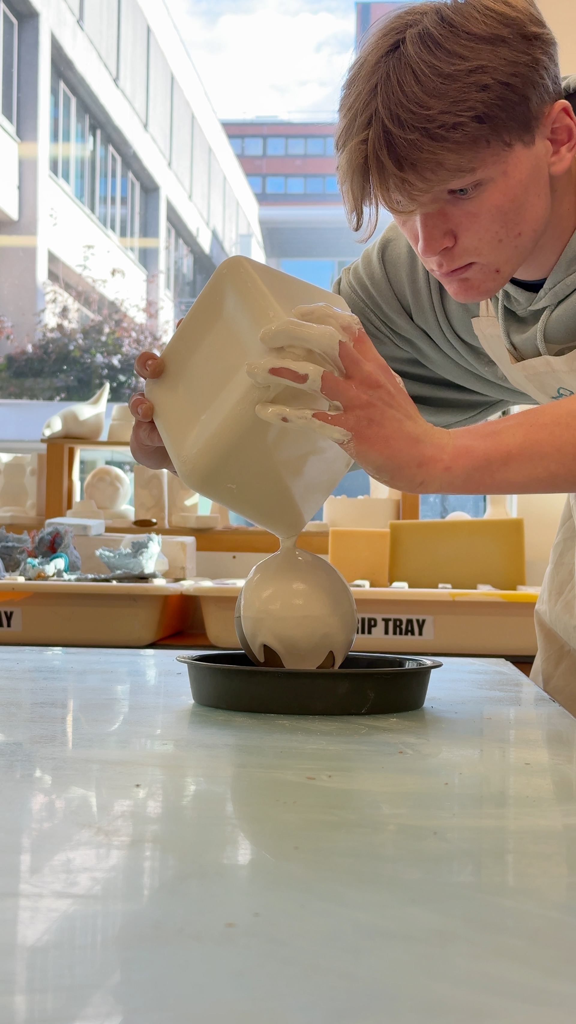 Pouring plaster onto the slip bauble.