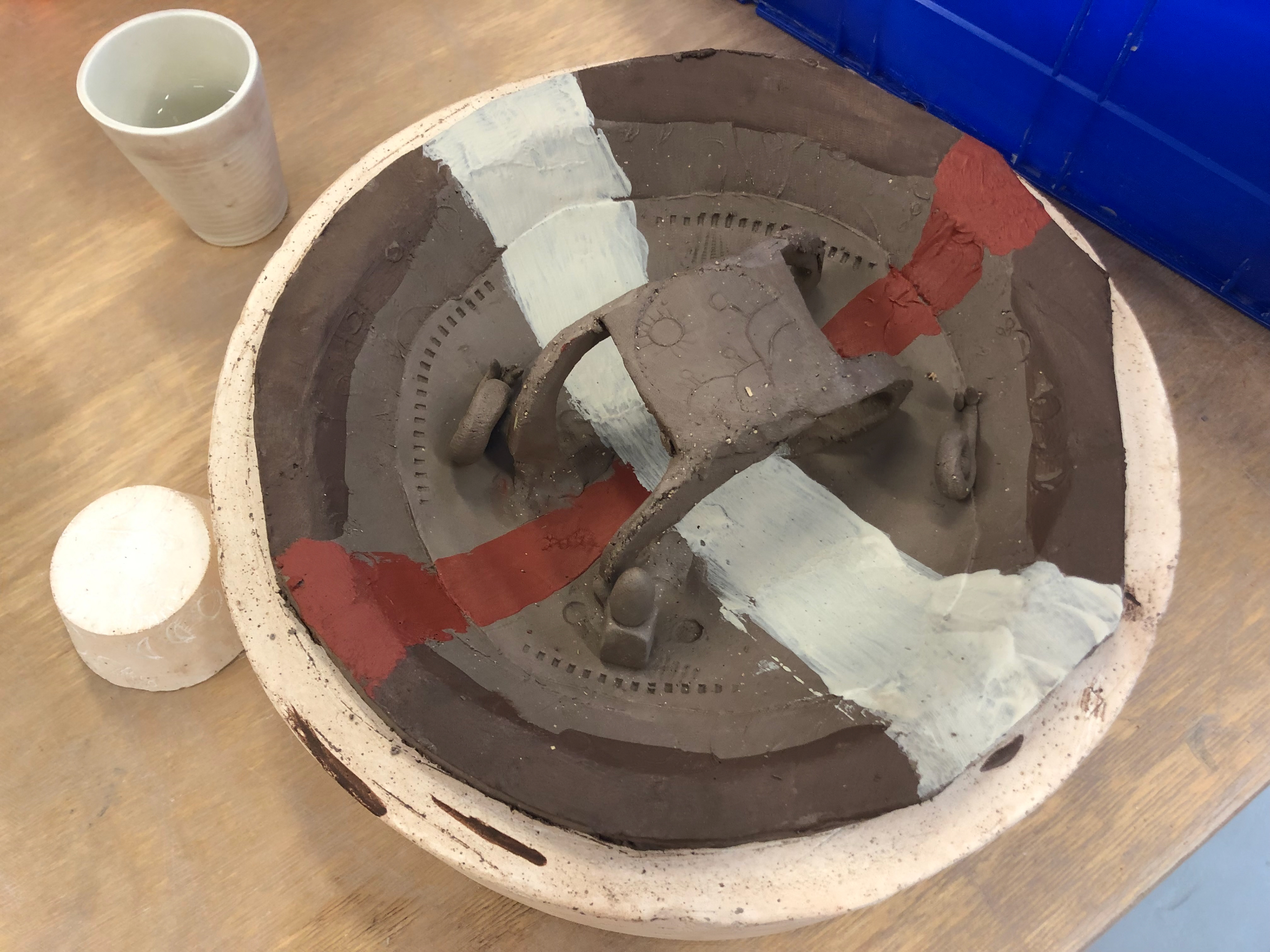 I added a few snails and a little face. The face is two circular indents and uses the cog's teeth as a mouth, the nose is a small block of clay with a cylindrical shape sit on it.