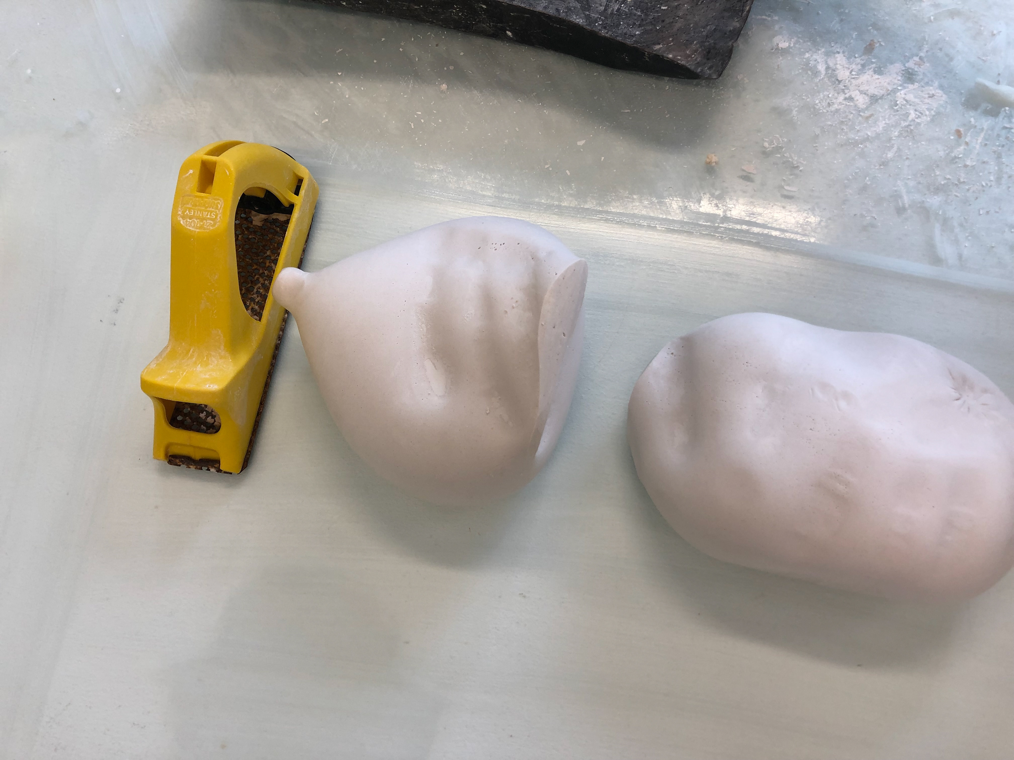 The surform is used to smooth the plaster along with water and a scalpel