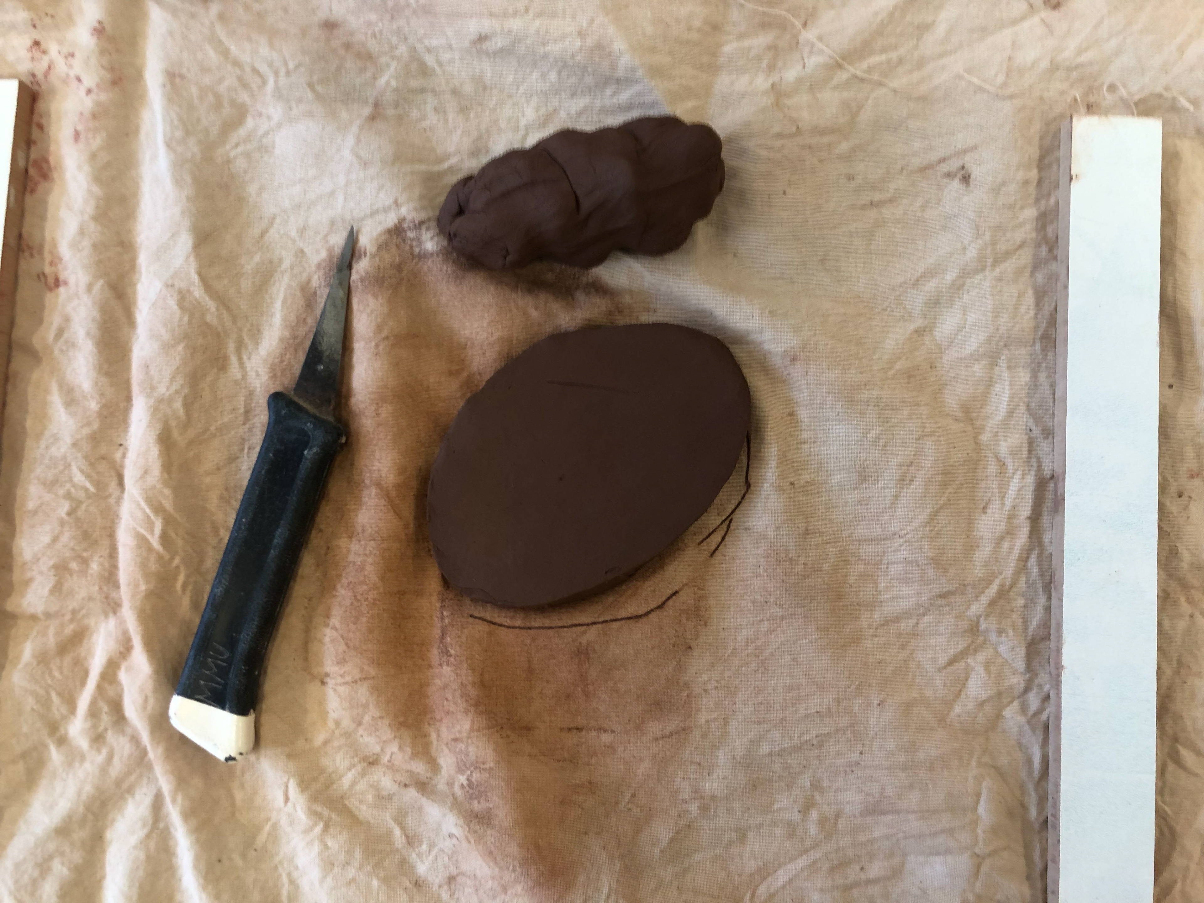 I rolled the clay and used a knife to cut out the centre of my sketch.