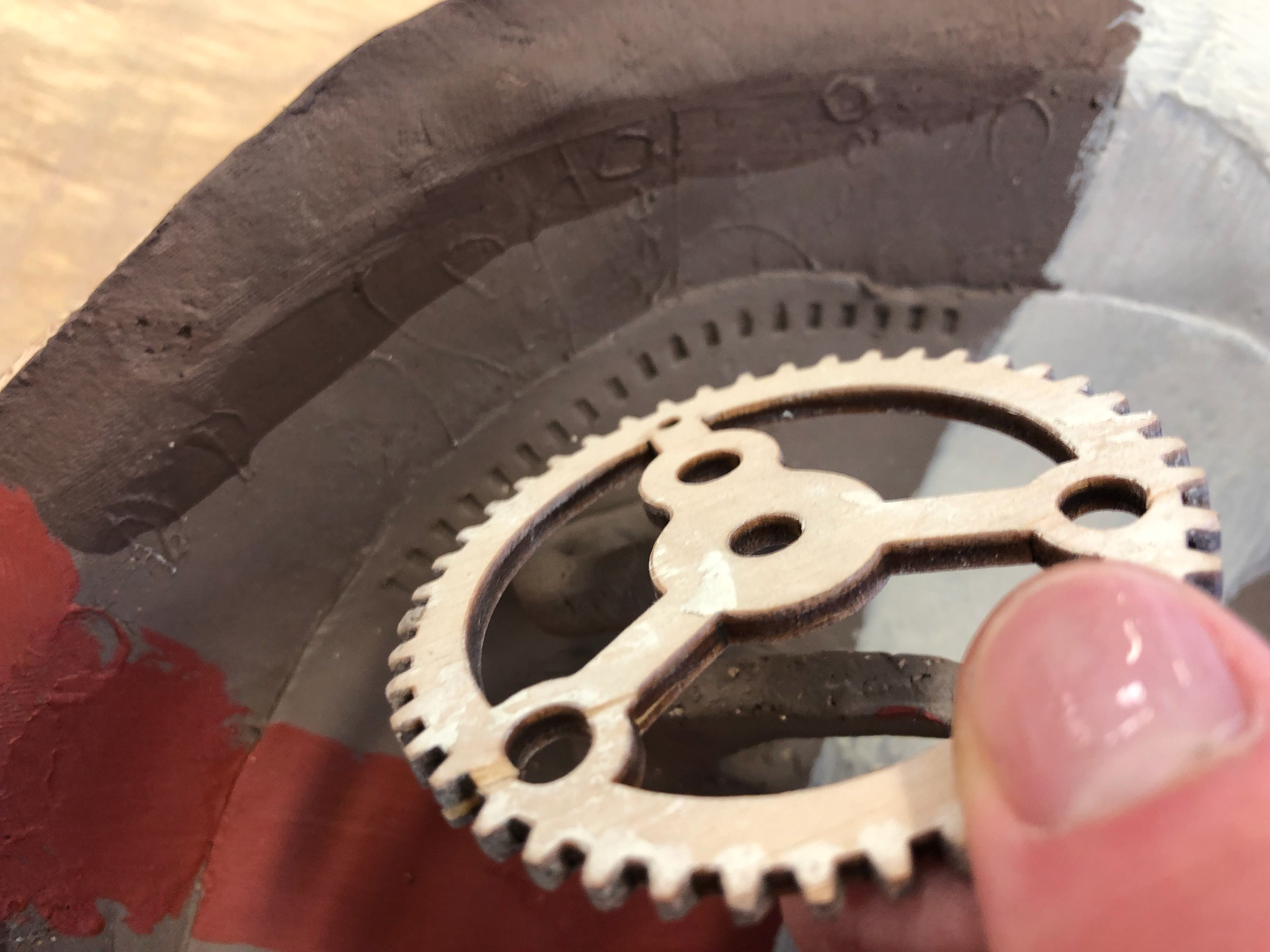 I used a cog to imprint the teeth just below the imprint of the intaglio.