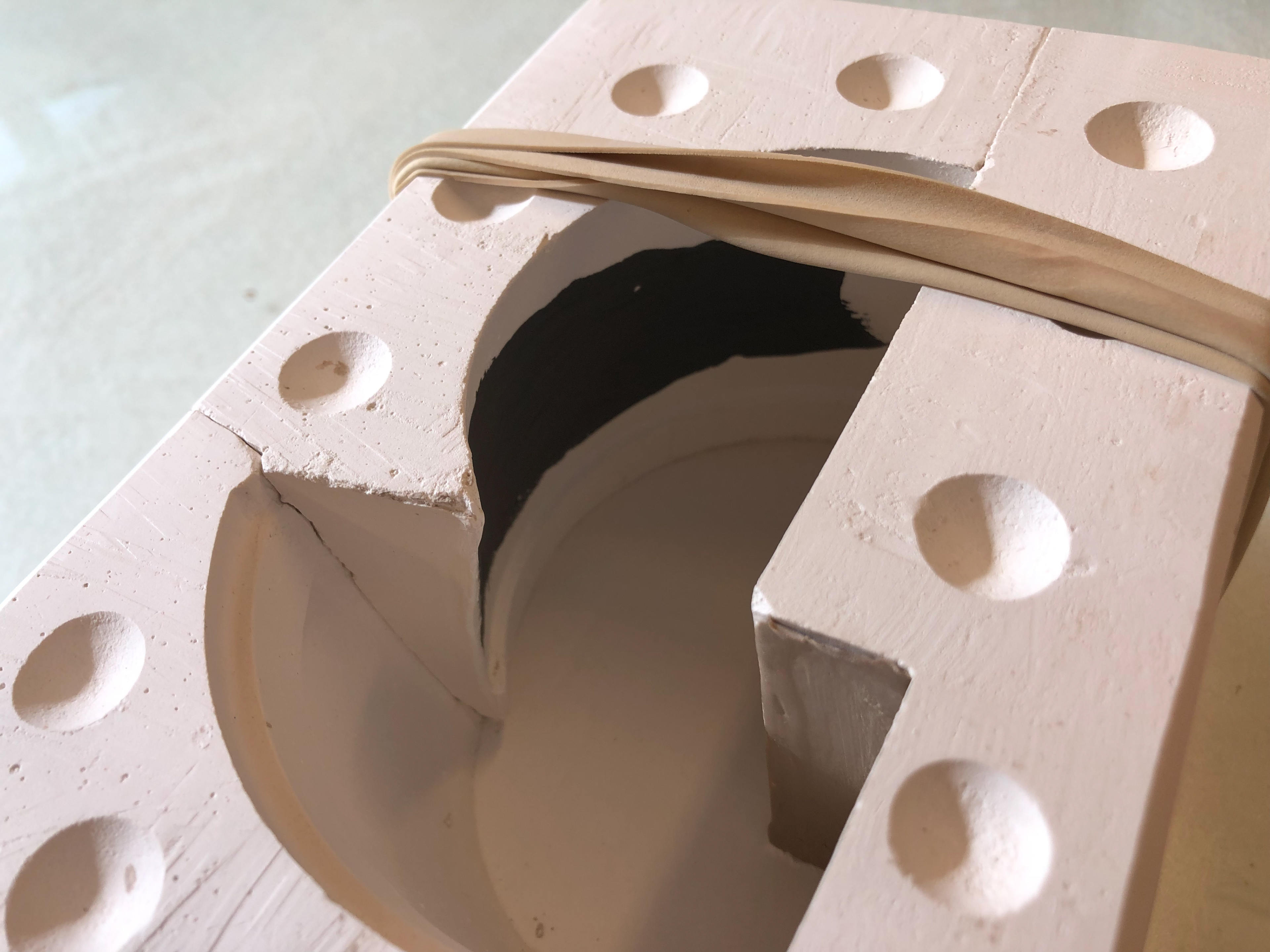 Black slip painted onto the left side of the mould.
