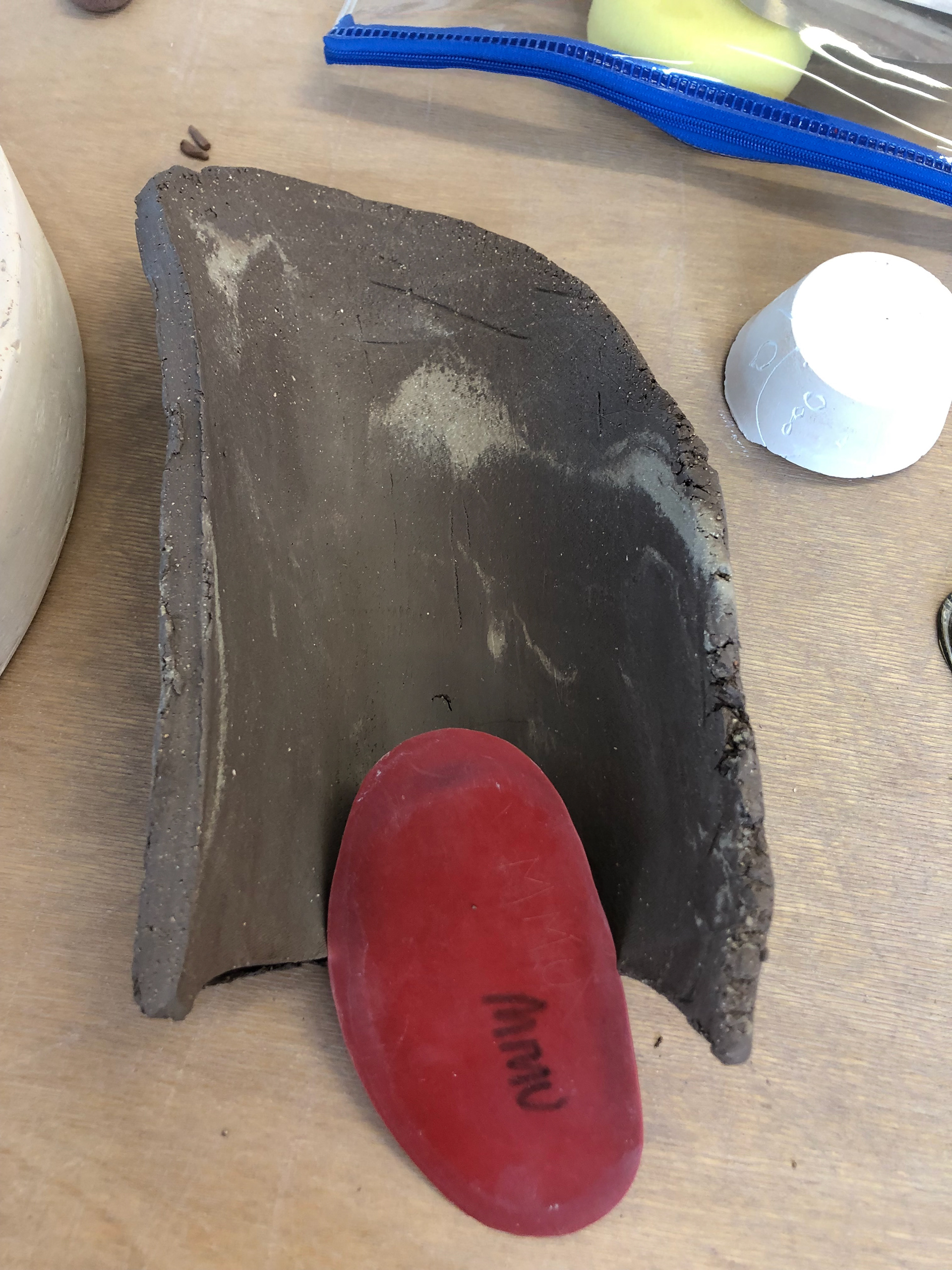 Initial clay piece with rubber kidney to smooth.