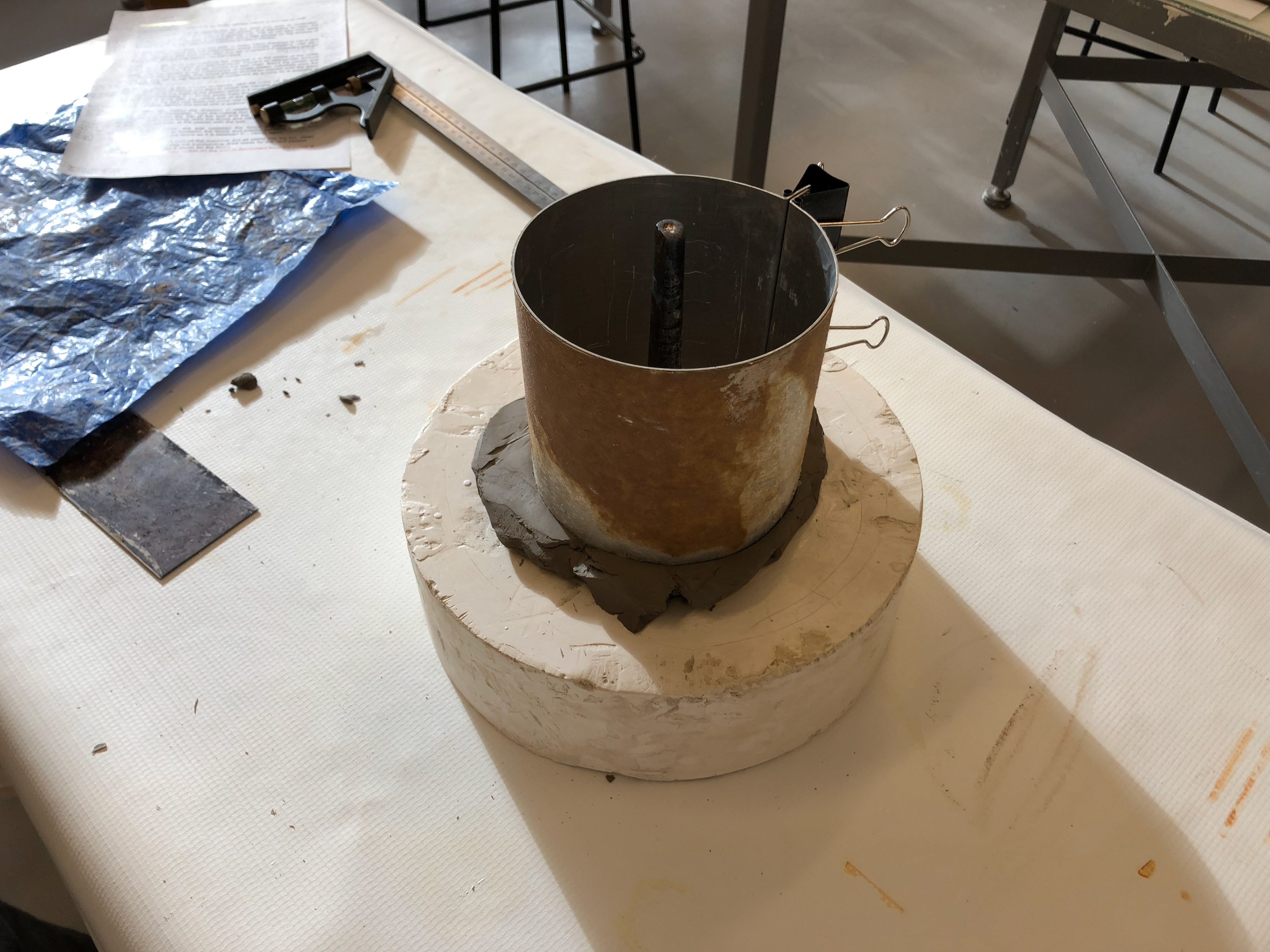 We used a circular metal cottle and make sure it digs into the clay.