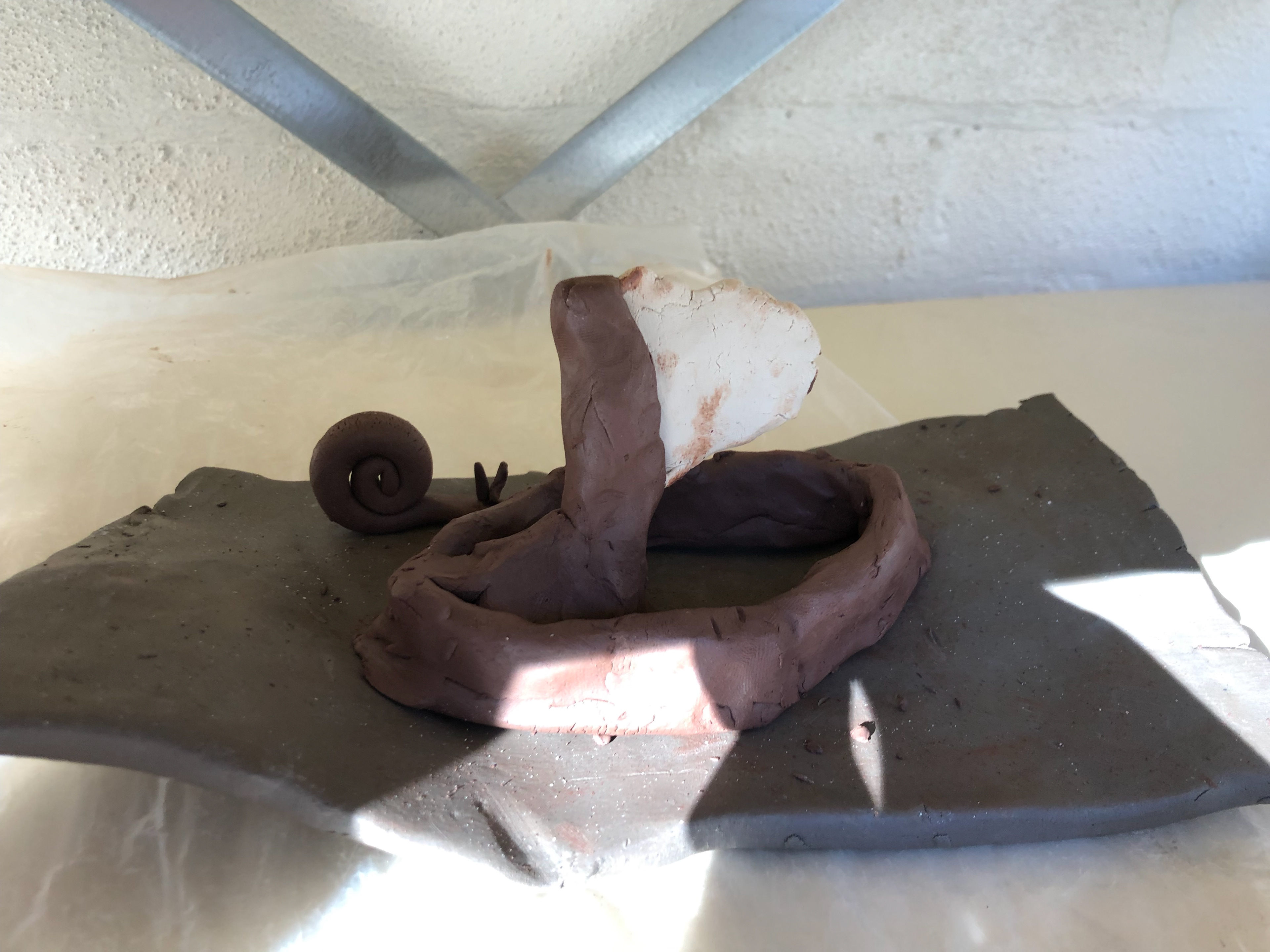 The sail was heavy and caused balance issues so I place more terracotta at the base of the mast and joined the mast to the boat.