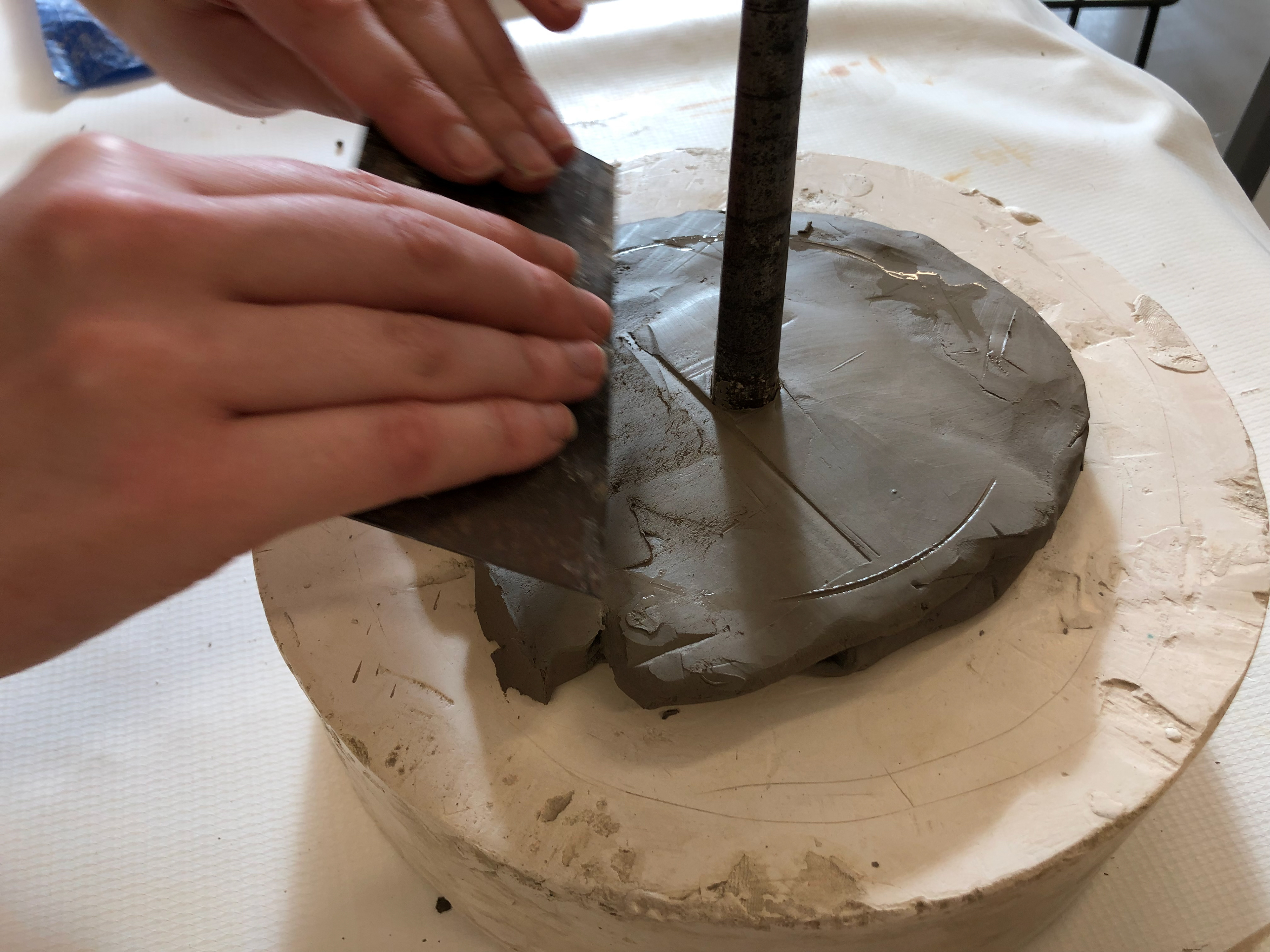 Cottle it up so the clay covers the mandrel head and make sure the mandrel is in the centre.