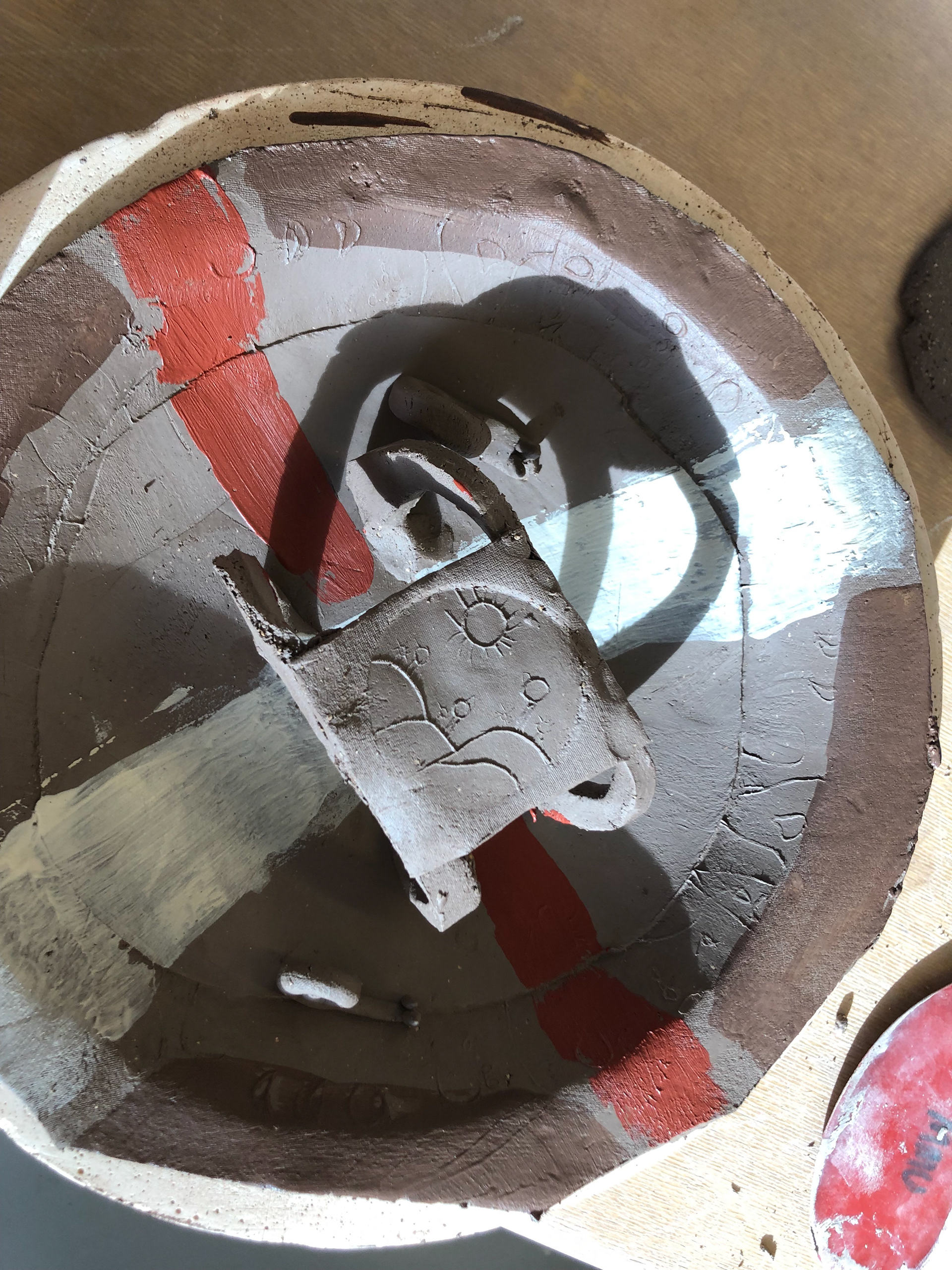 I then imprinted the top of the intaglio into a piece of clay and attached it to the arches.