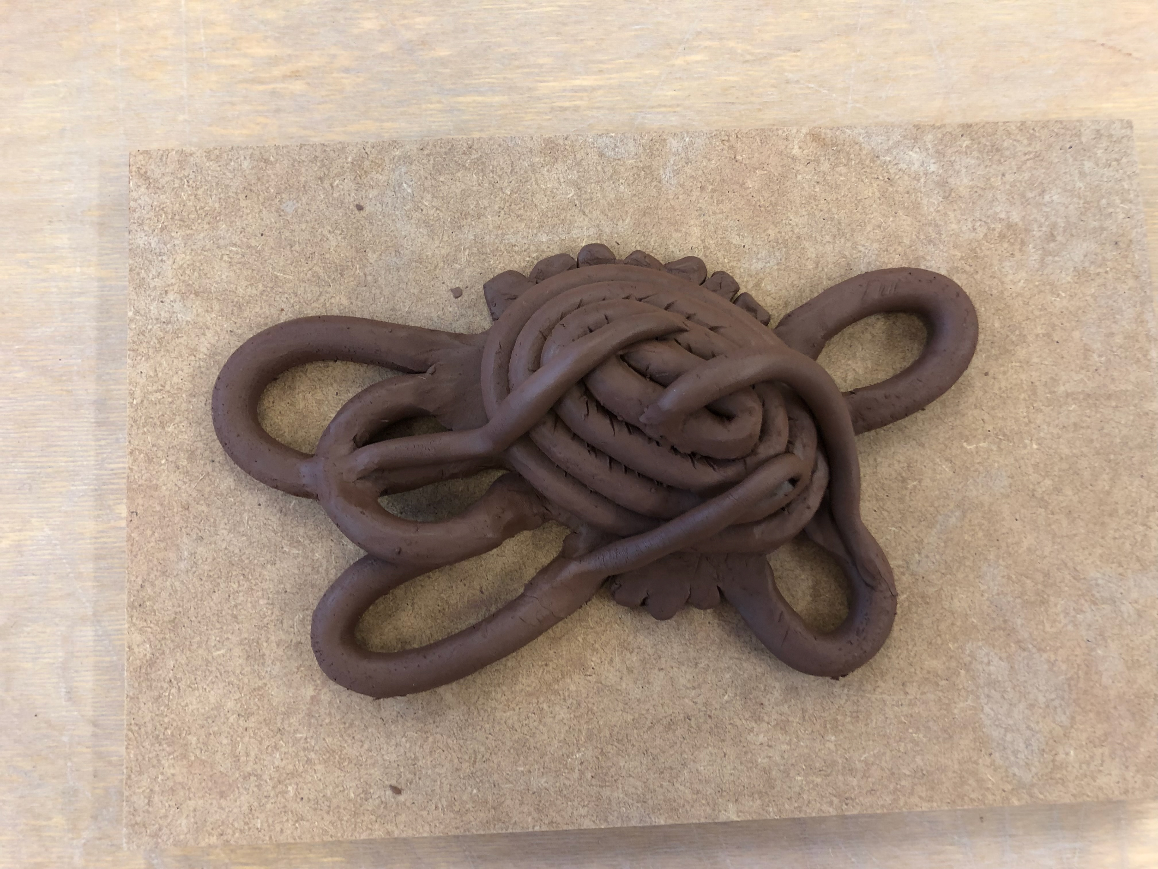 I added some thinner and smaller rolls of clay and threw them on to add chaos