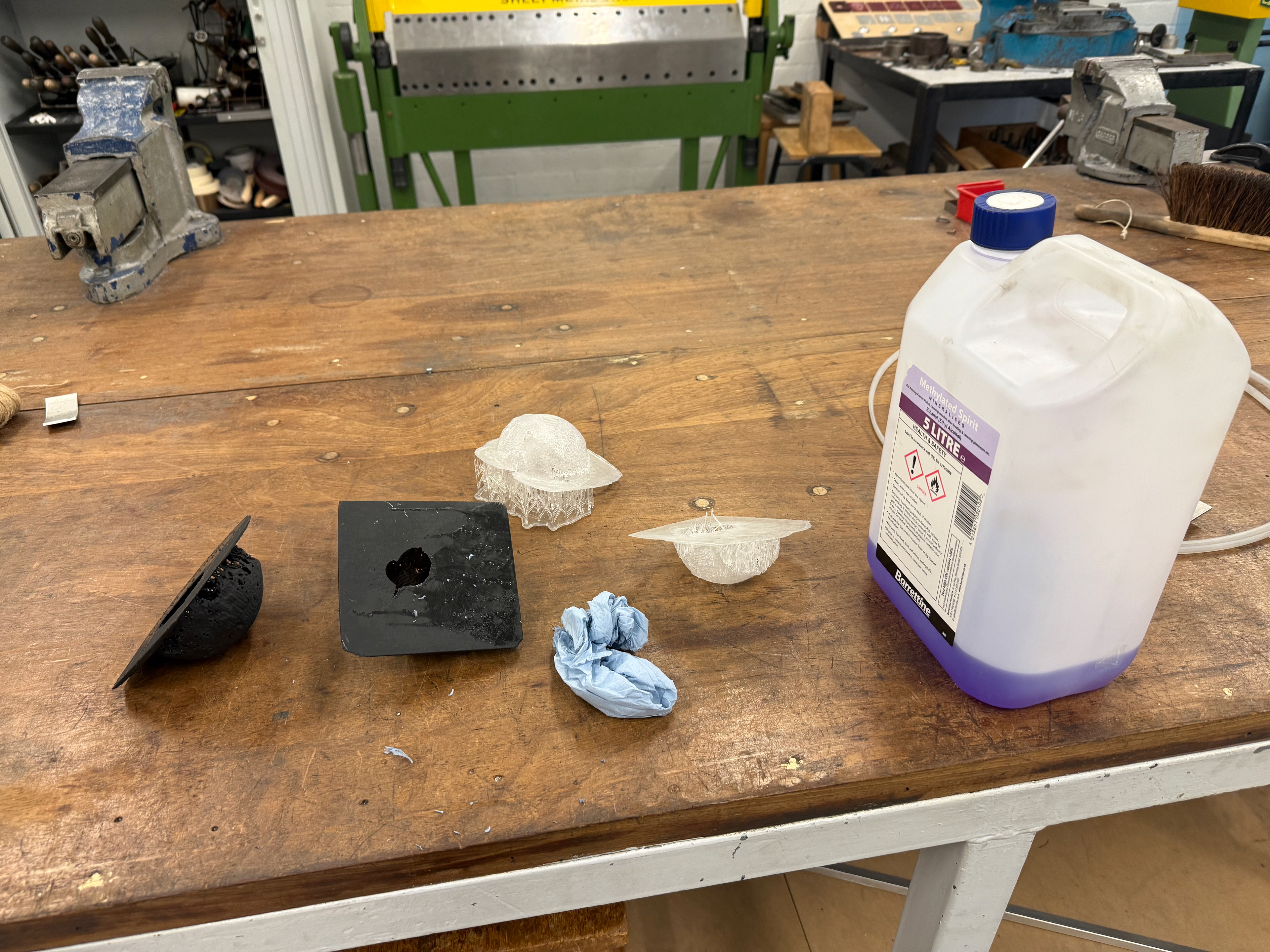 Using Methylated Spirit to remove the uncured resin which will remove the stickiness of the objects.