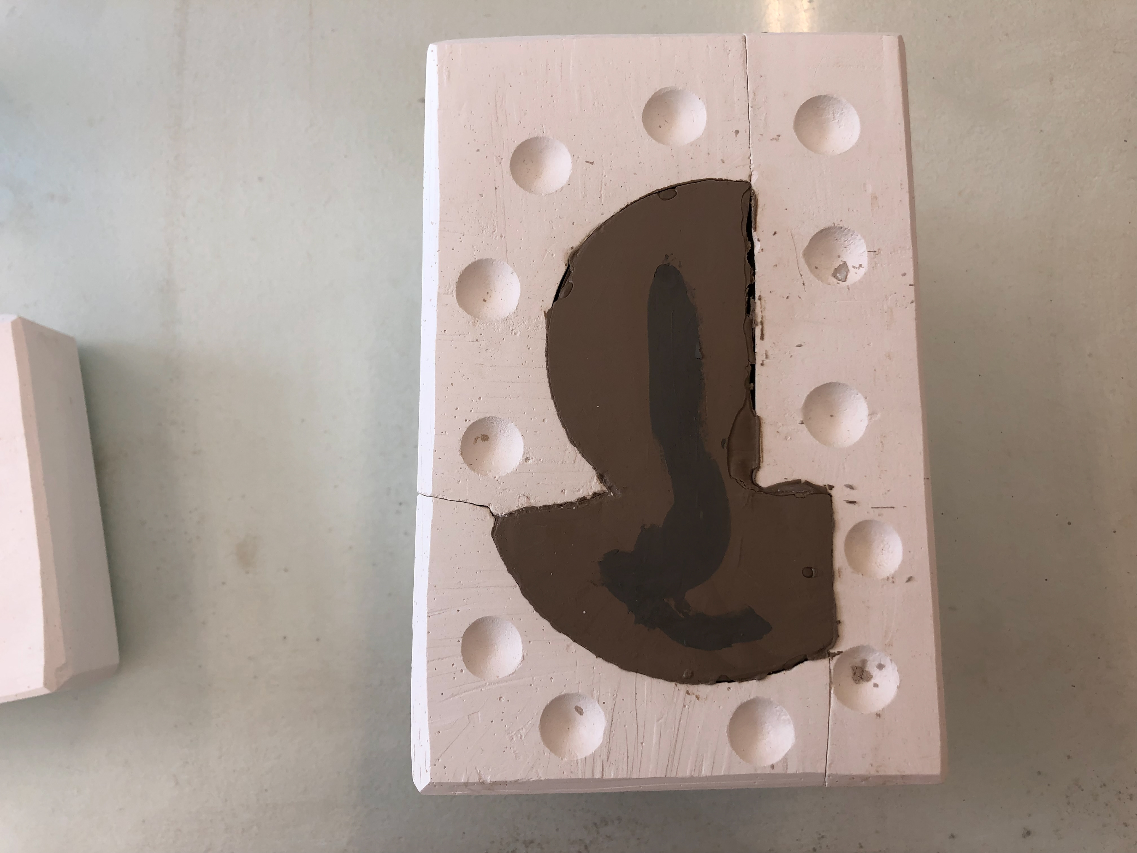 I painted the top of the mould so the second slip pour would incorporate it.
