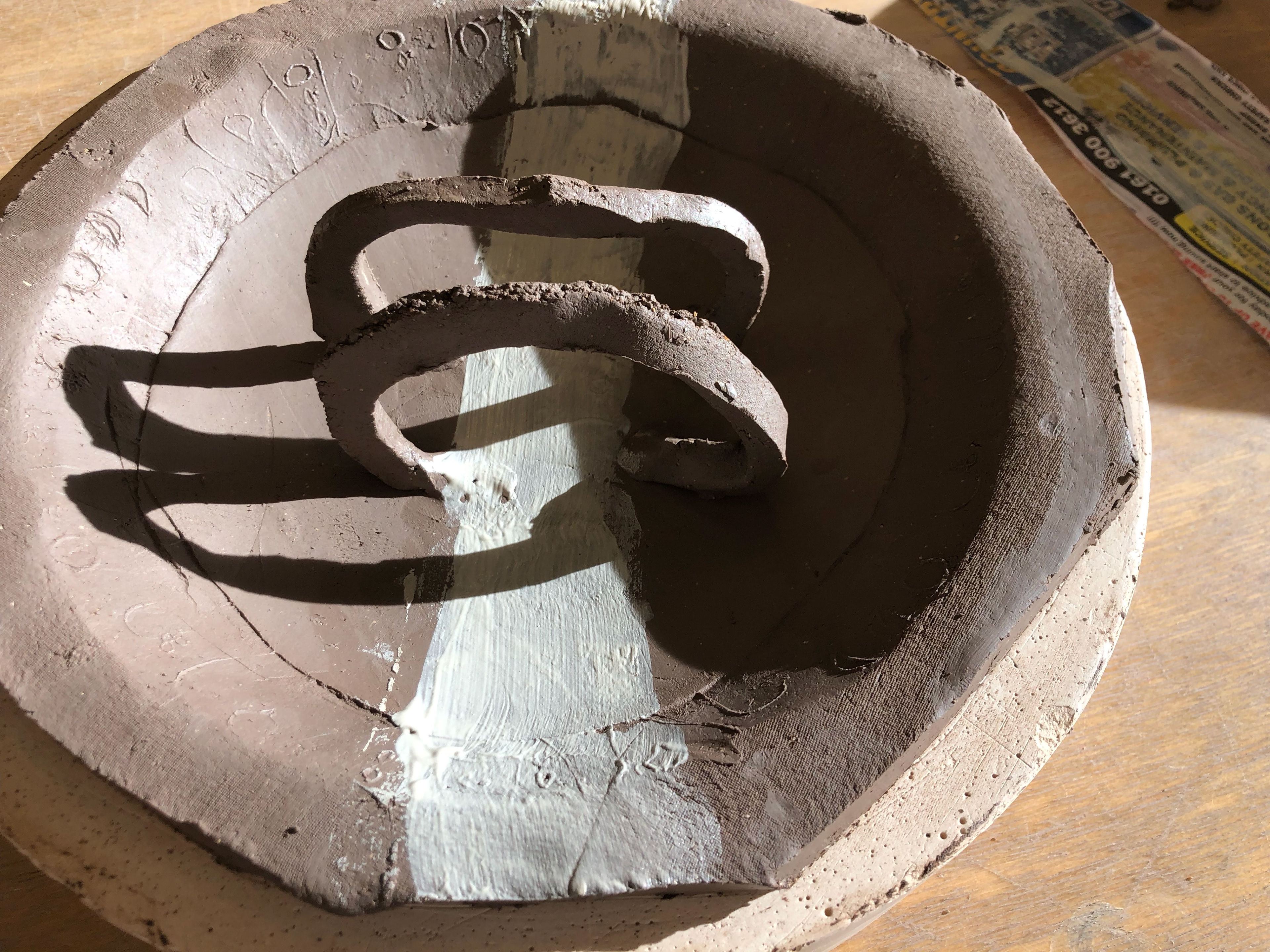 I used porcelain slip to paint a white line through the arches.