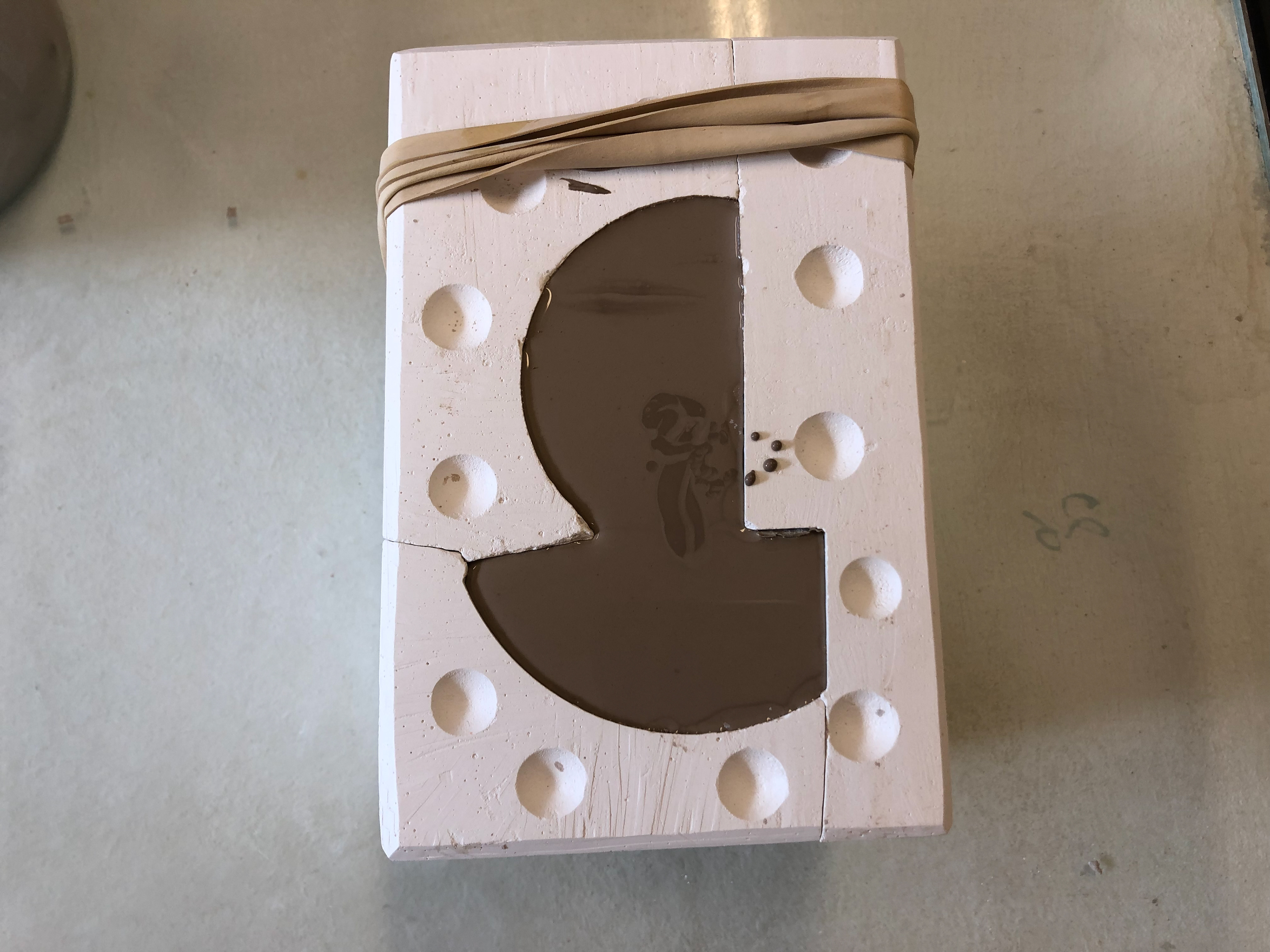 Mould filled with slip.