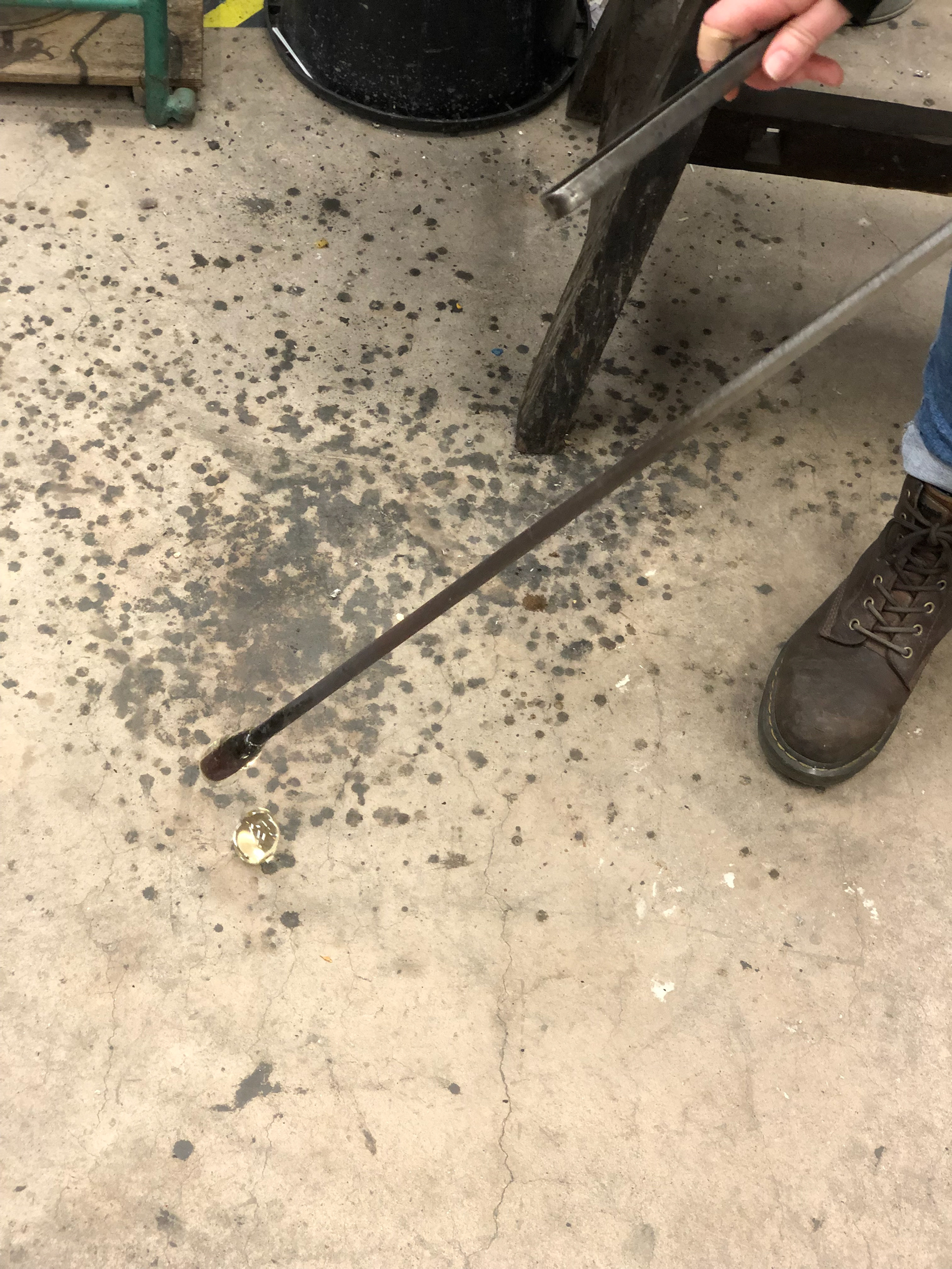 Using the back of the tweezers to tap against the pipe to break the glass off cleanly.