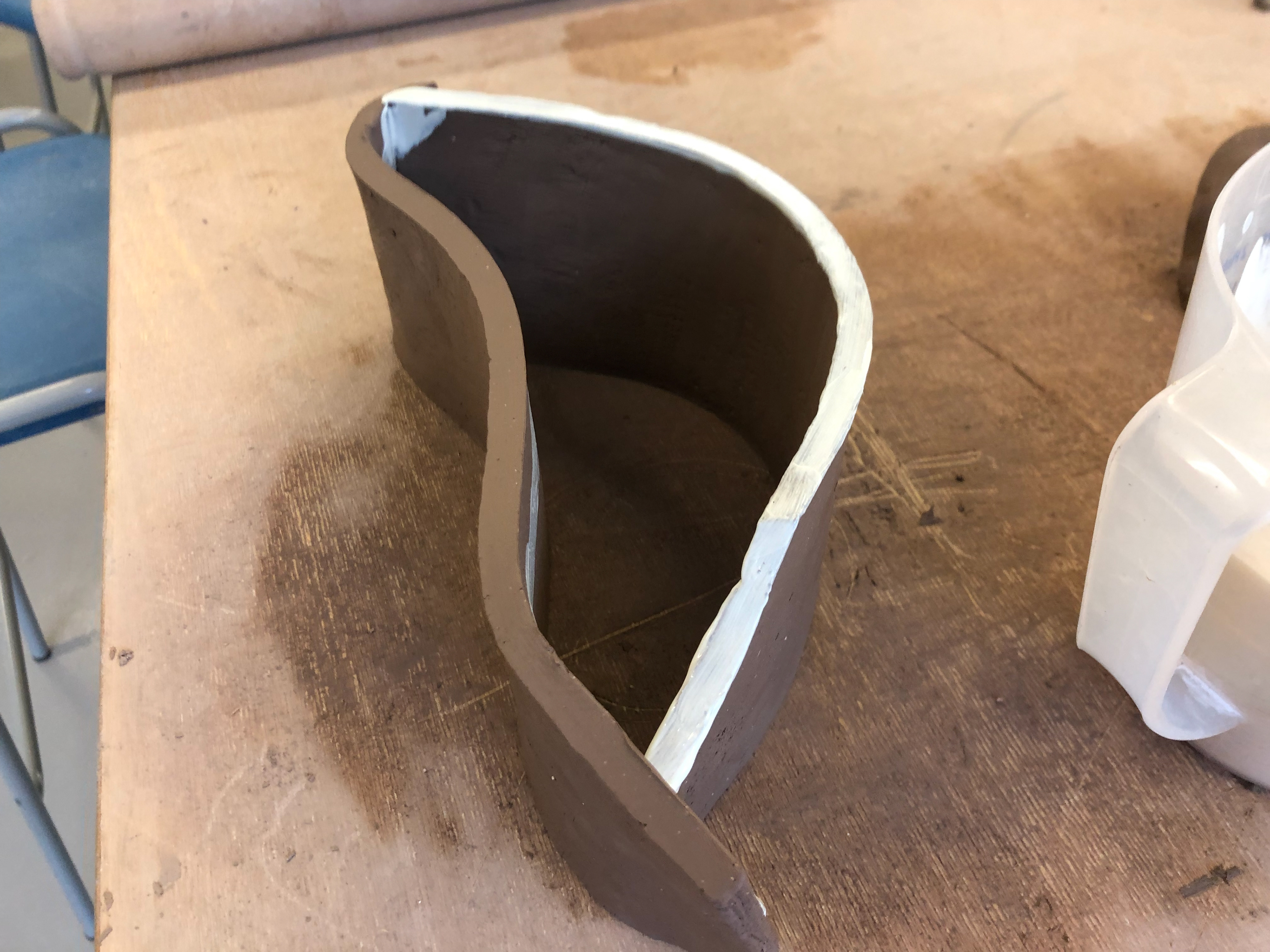 Connecting two parts, one with white slip on the inside and another with white slip on top