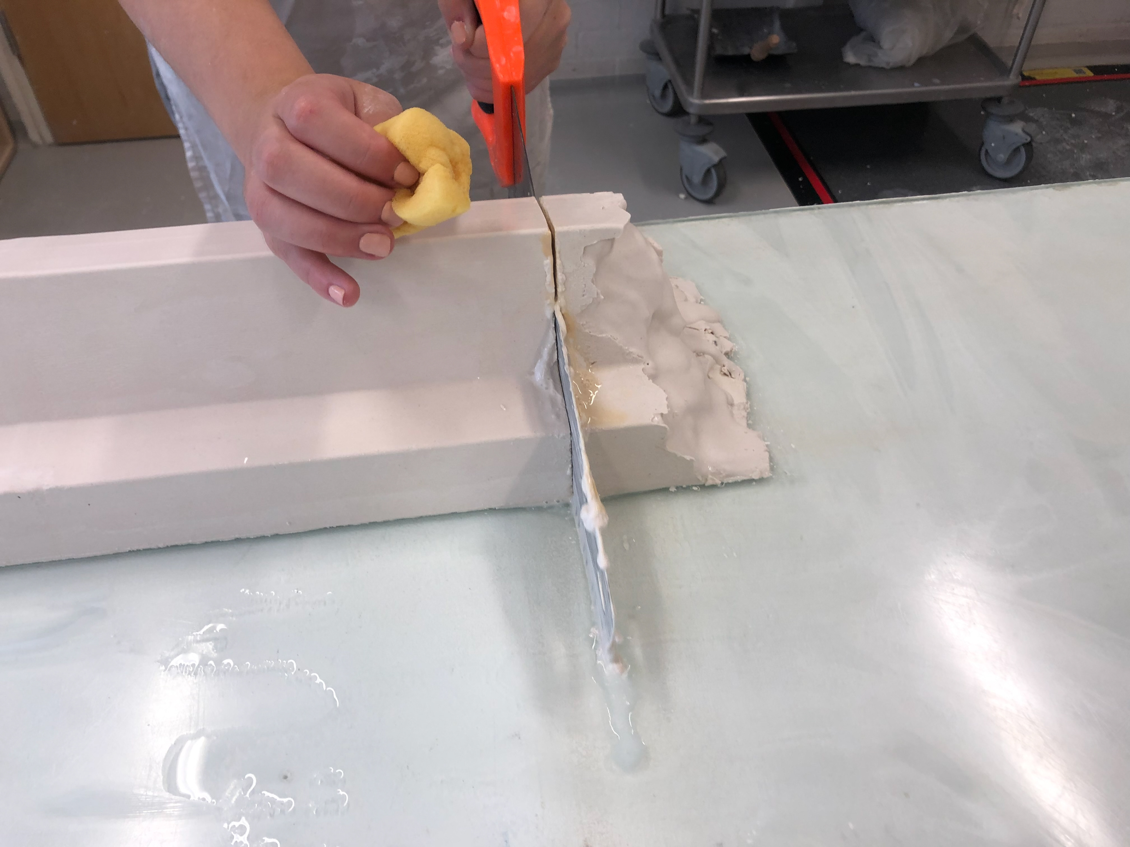 Using a saw and water to get a clean cut through both pieces